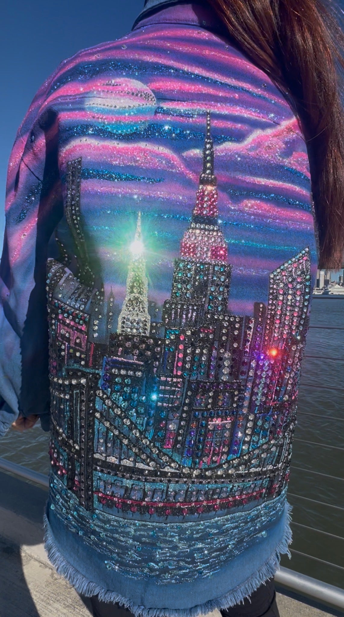 Denim jacket with a cityscape Loria NYC Art design featuring the Empire State Building, embellished with rhinestones.