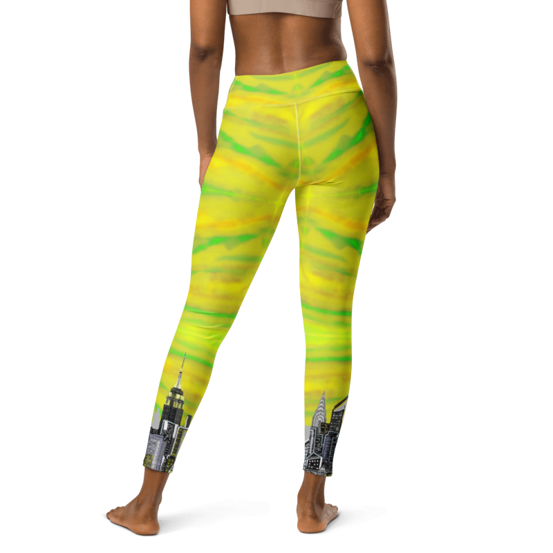 Yellow and green Loria NYC Art leggings with cityscape cuffs on a white background