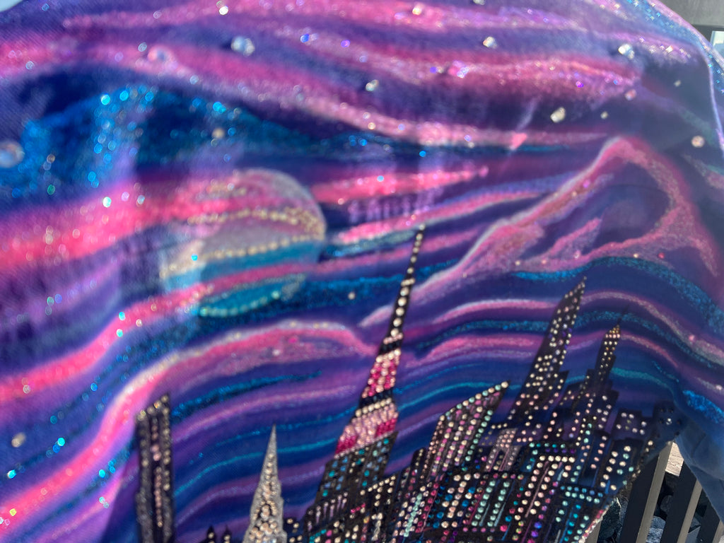 Fabric with a cityscape Loria NYC Art design featuring lights and glittery texture.