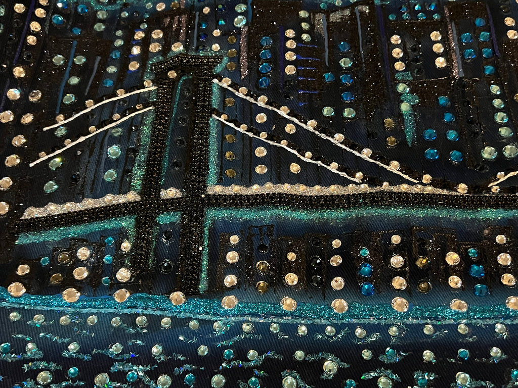 Decorative fabric with a cityscape Loria NYC Art design featuring lights and a bridge.