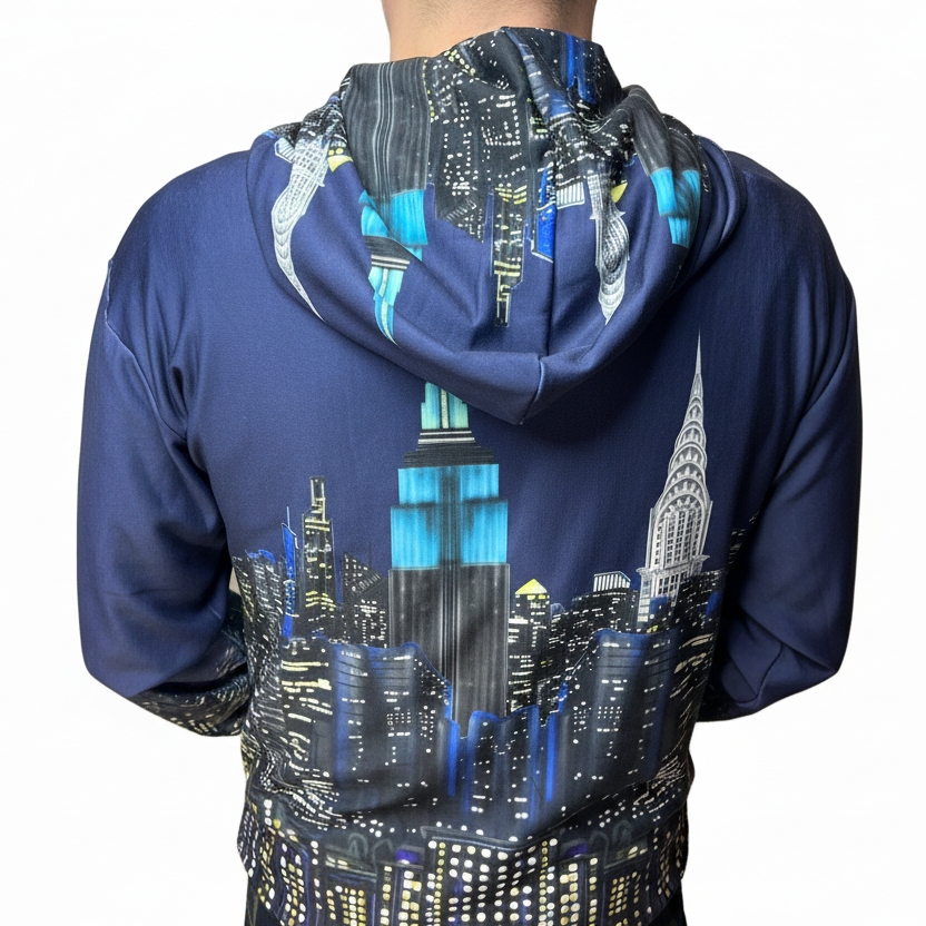 Navy blue hoodie with a cityscape Loria NYC Art design on the back, worn by a person.