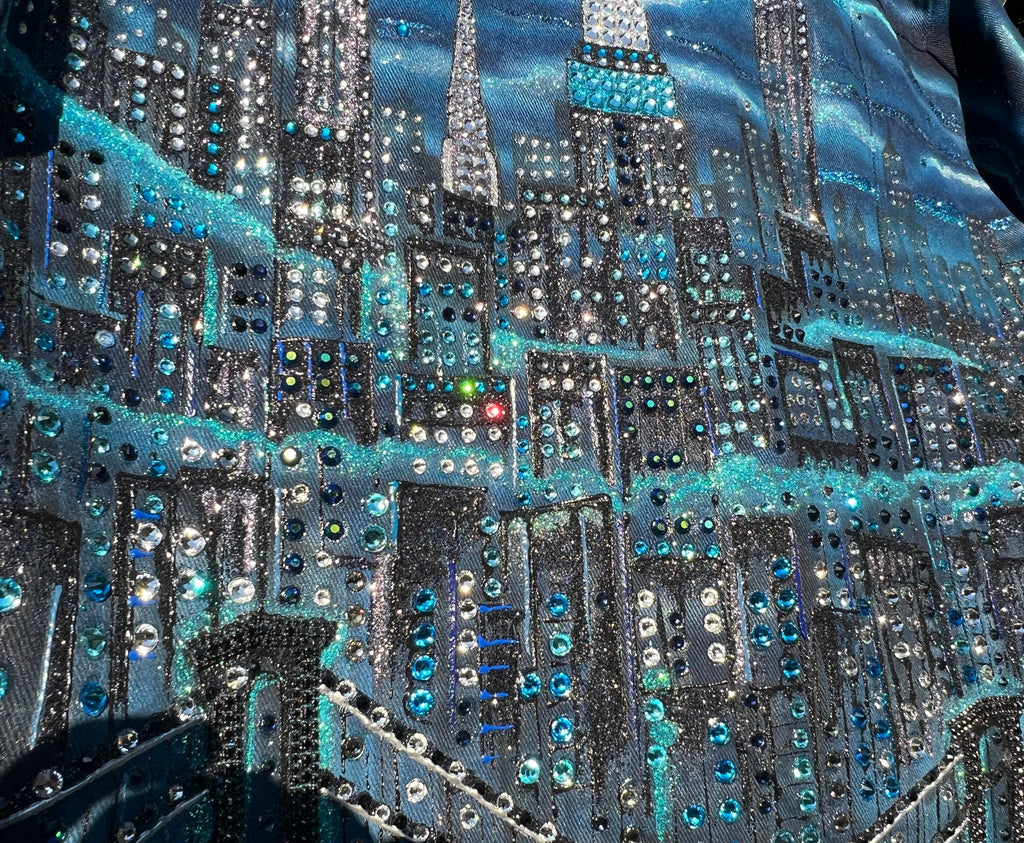 Close-up of a fabric with a cityscape Loria NYC Art featuring blue and silver colors.