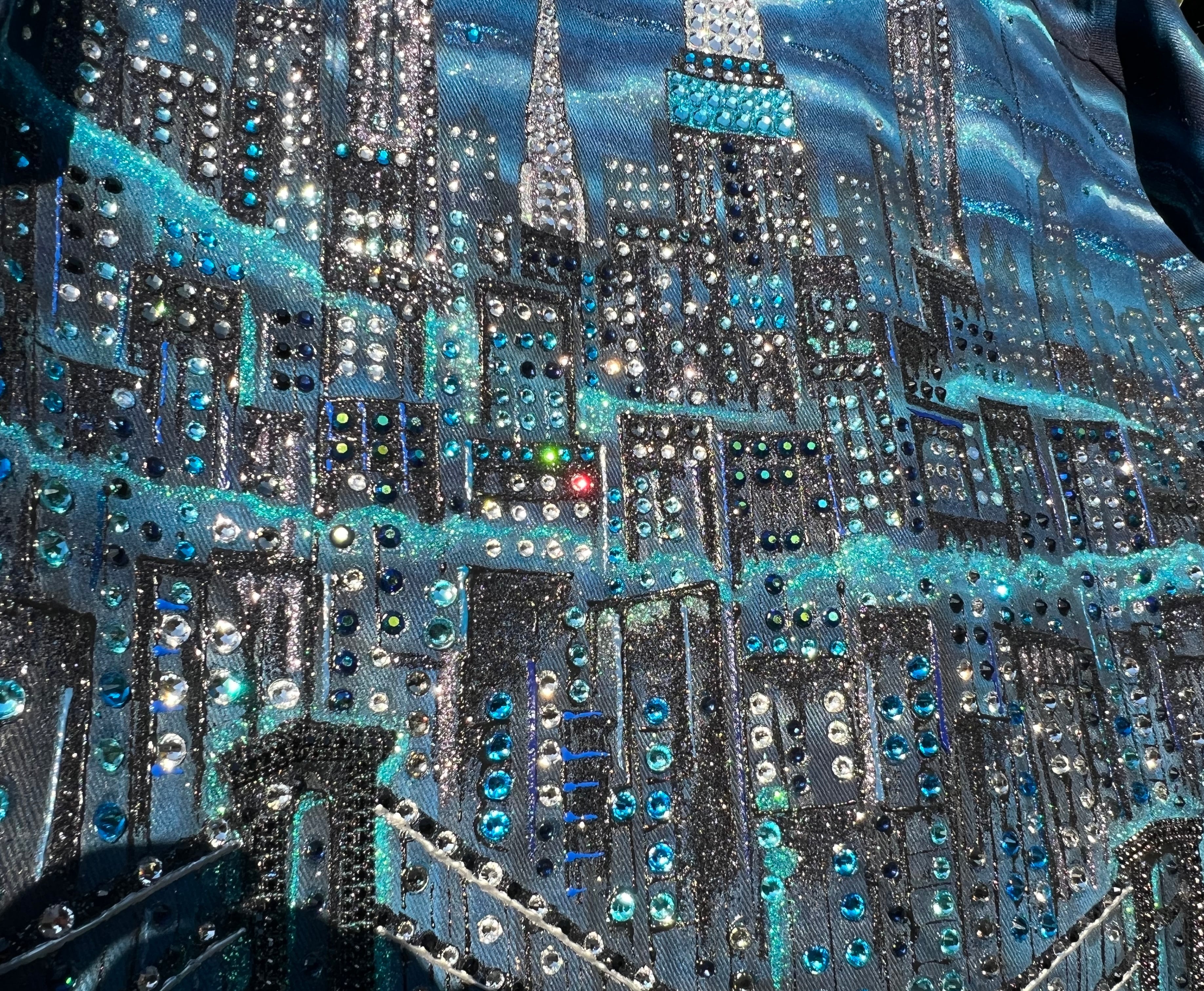 Close-up of a fabric with a cityscape Loria NYC Art featuring blue and silver colors.