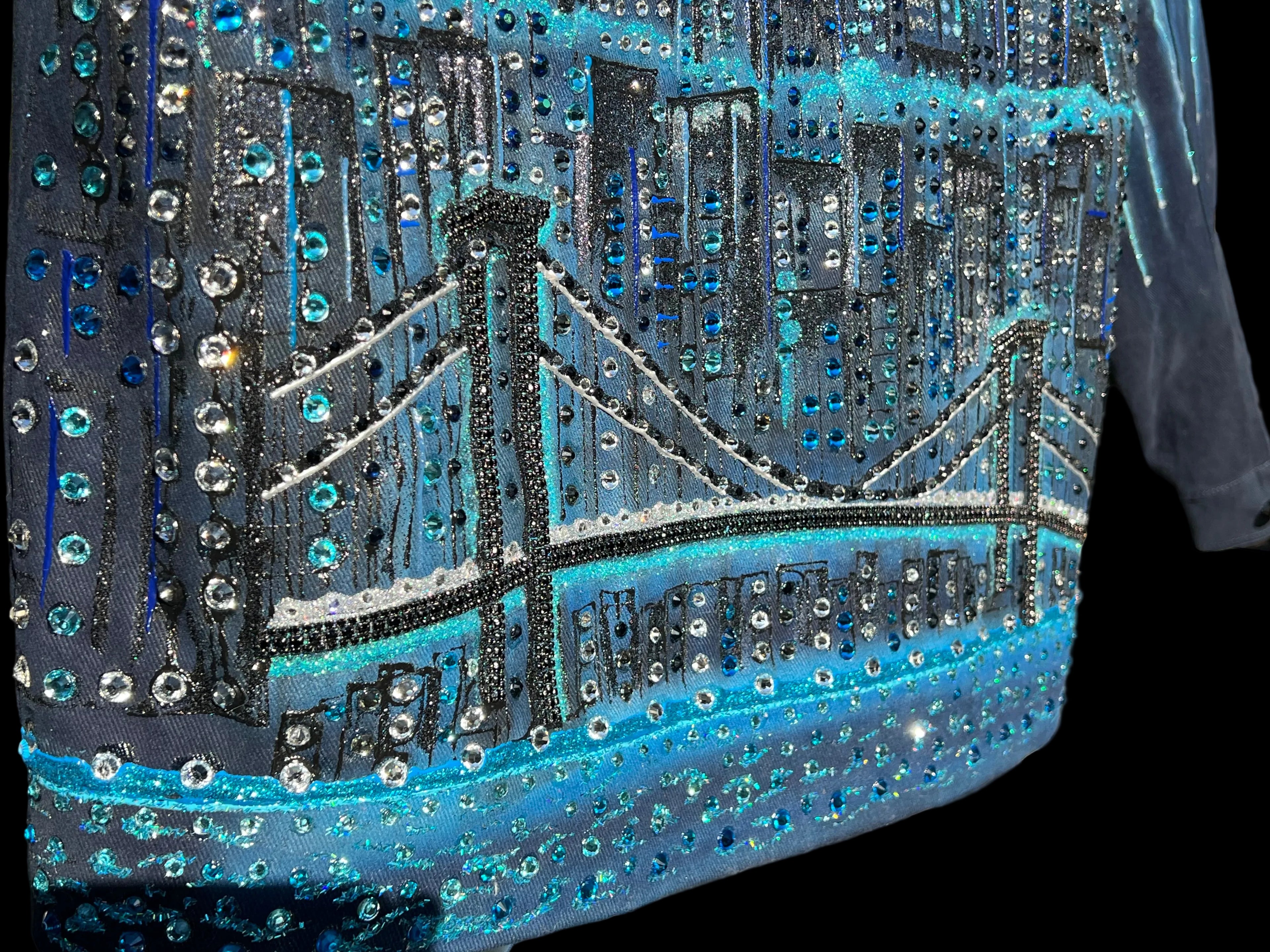 Close-up of a garment with a Loria NYC Art cityscape design featuring a bridge and skyline.
