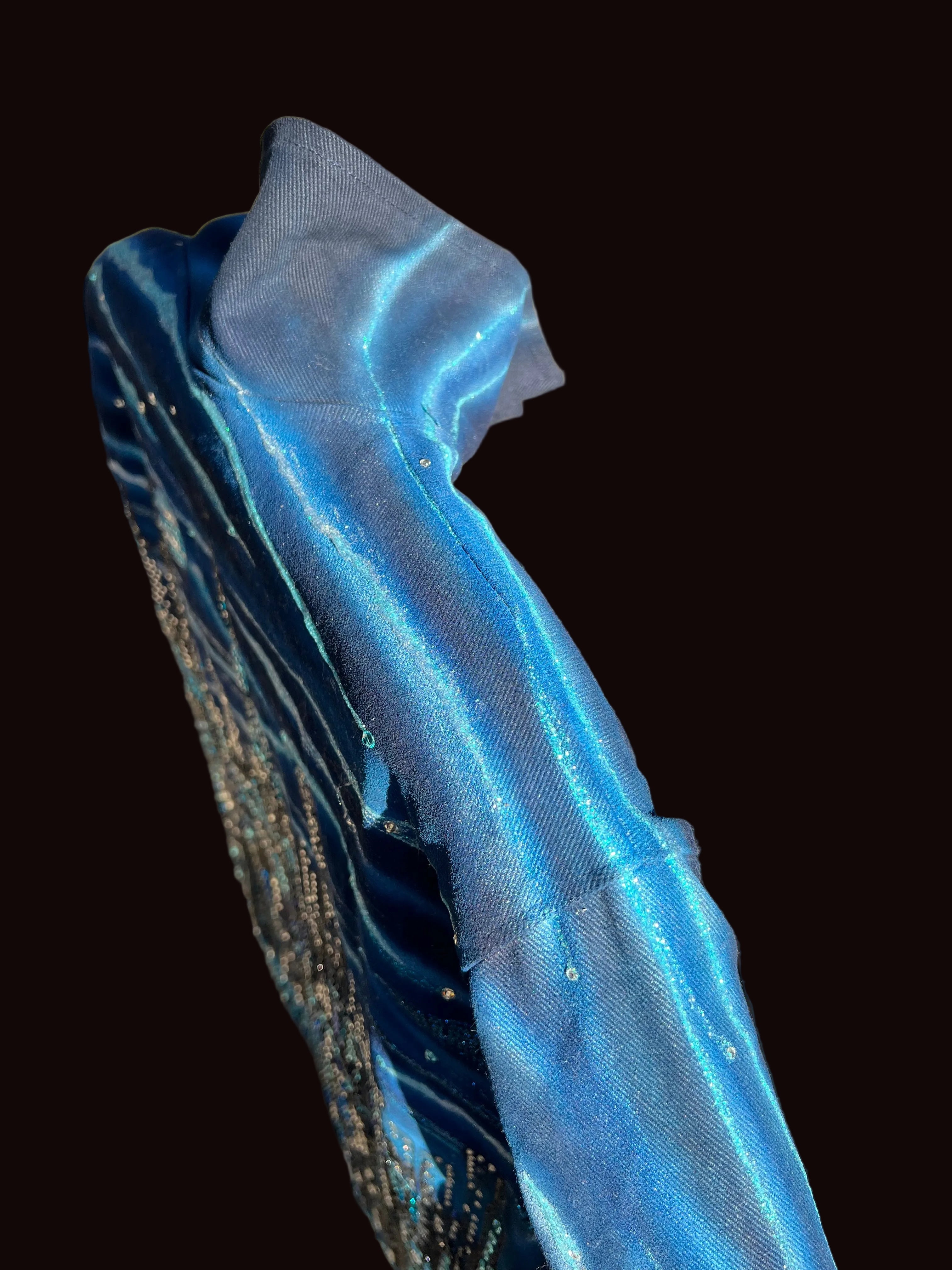 Top view of a Blue jacket with Loria NYC Art on the surface