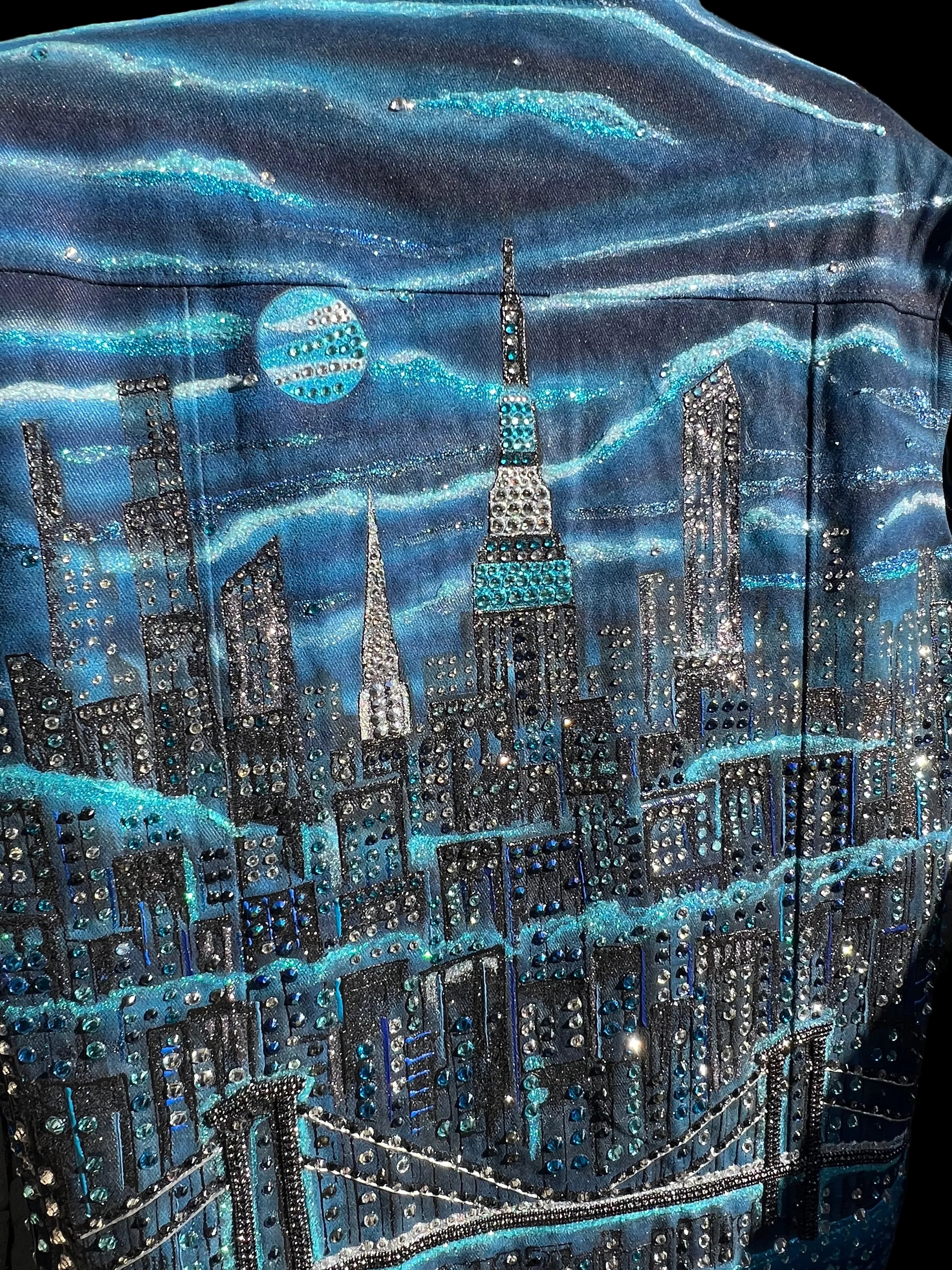 Close-up of a Loria NYC Art textured blue fabric with patterns and embellishments