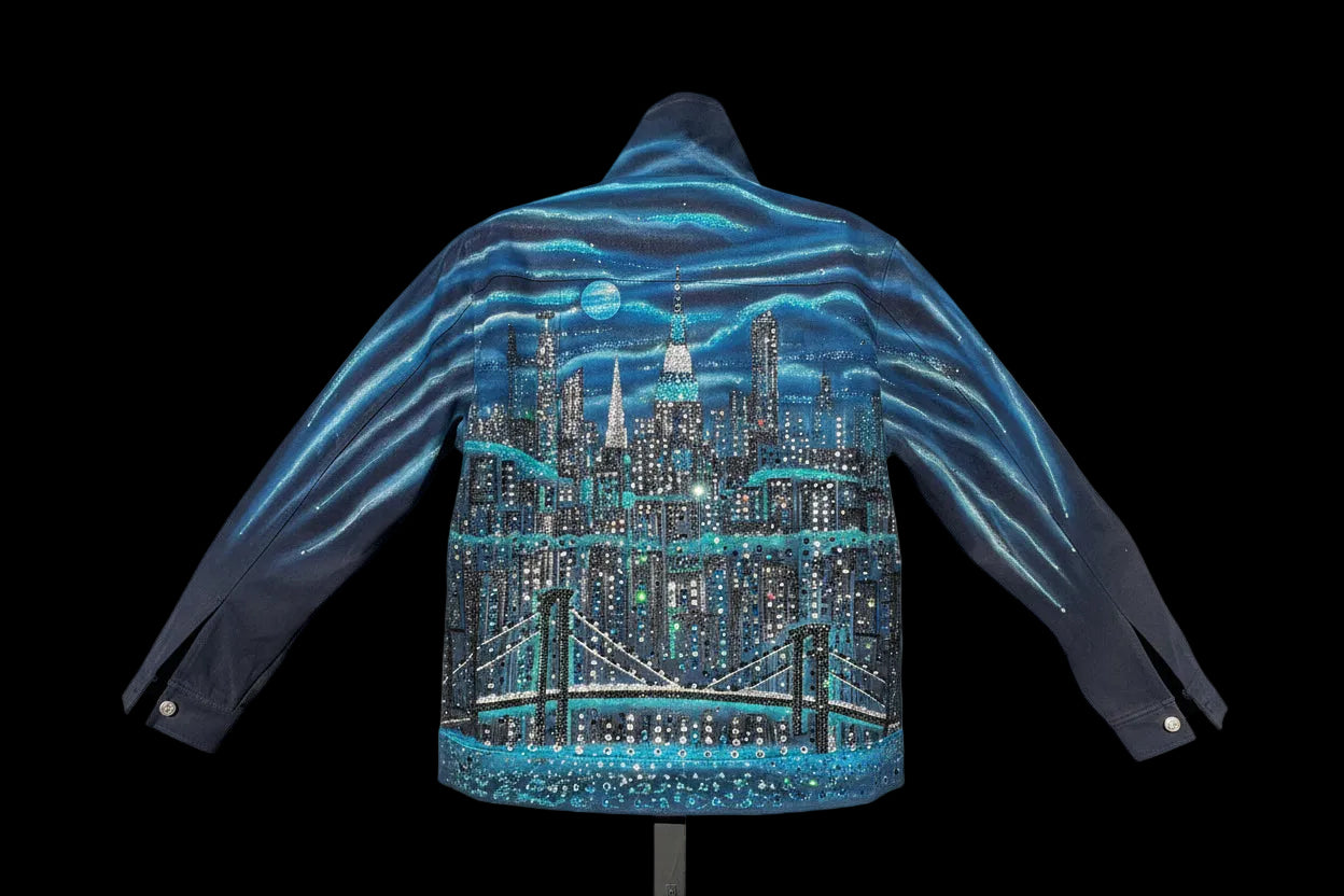 Hoodie with a cityscape design on a wooden table outdoors