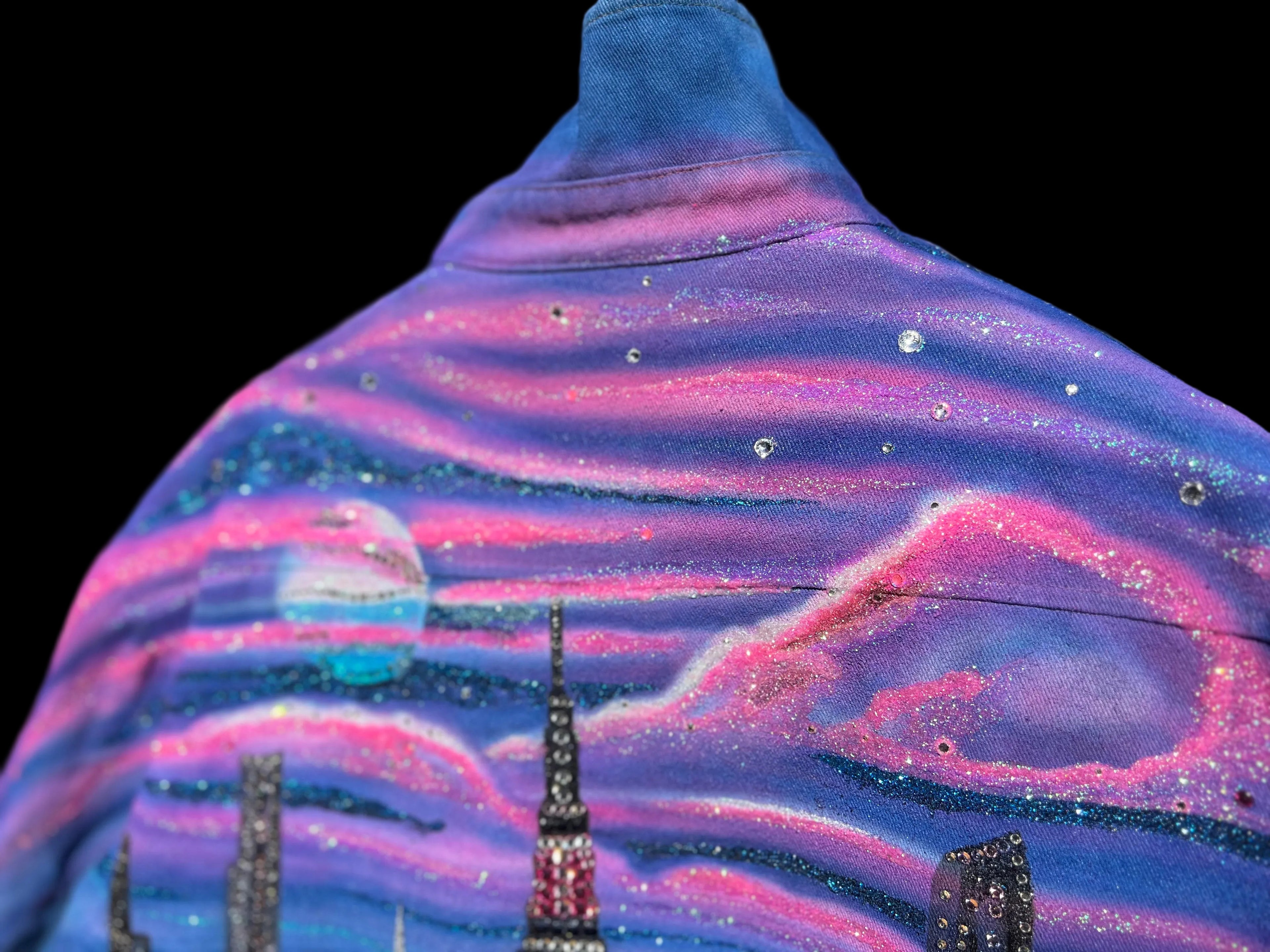 Jacket with a colorful, abstract Loria NYC Art design on a blurred outdoor background