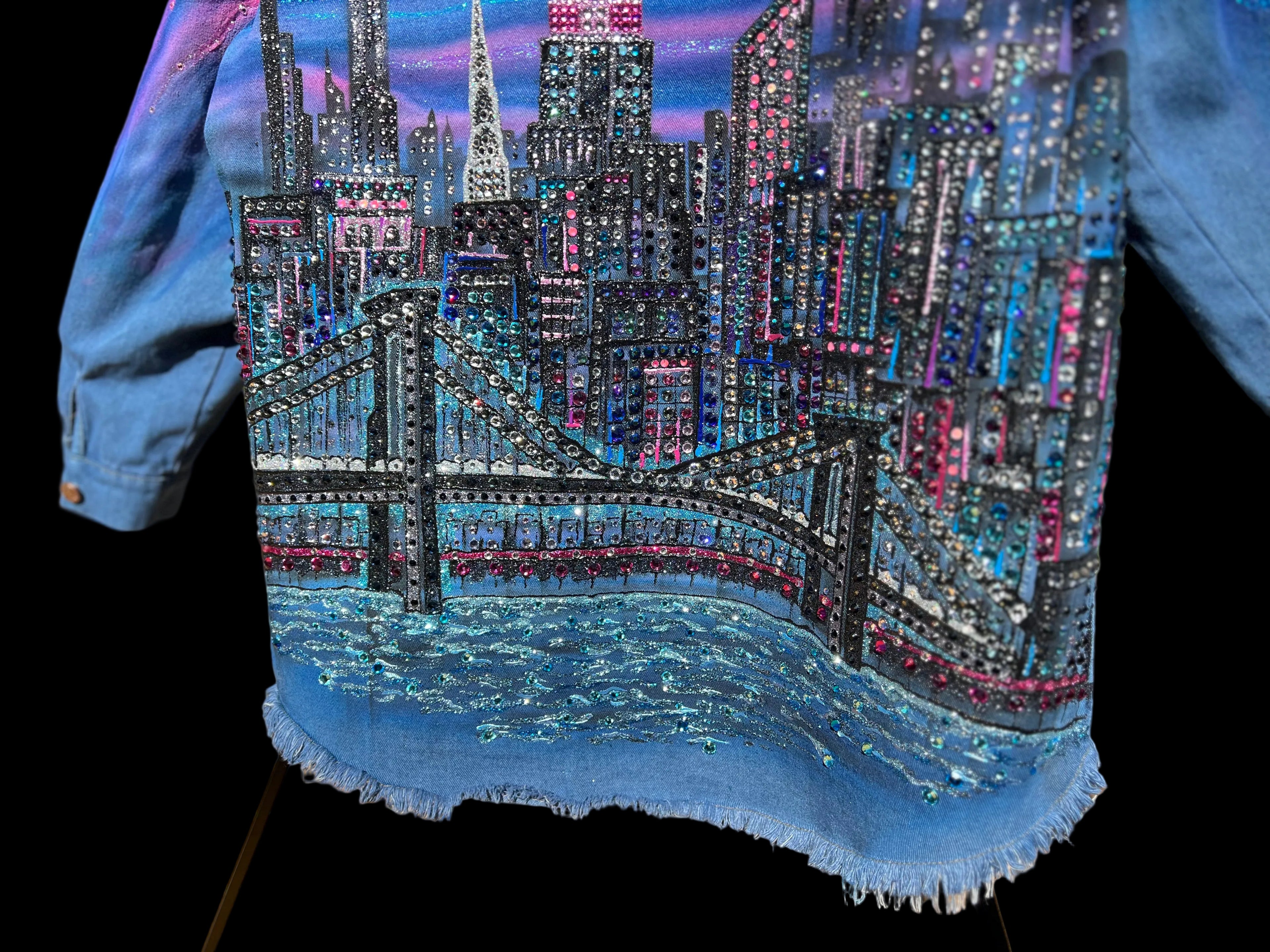 Denim jacket with a cityscape Loria NYC Art design featuring a bridge and skyline.