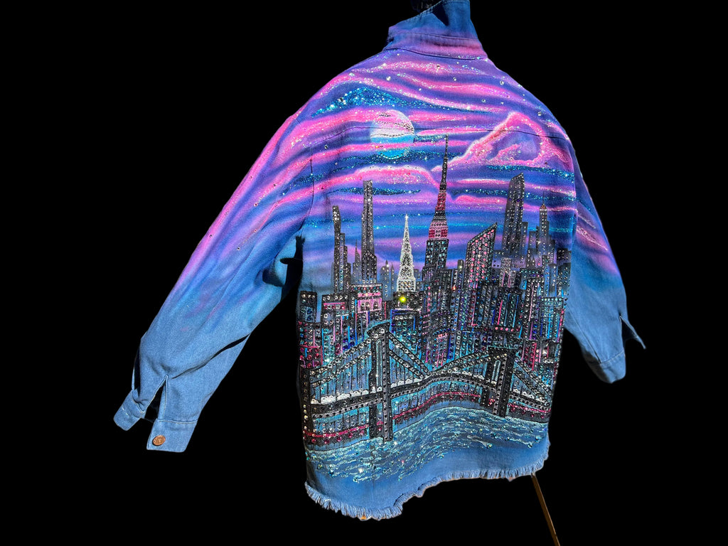 Blue jacket with a colorful Loria NYC Art cityscape design on a mannequin outdoors.