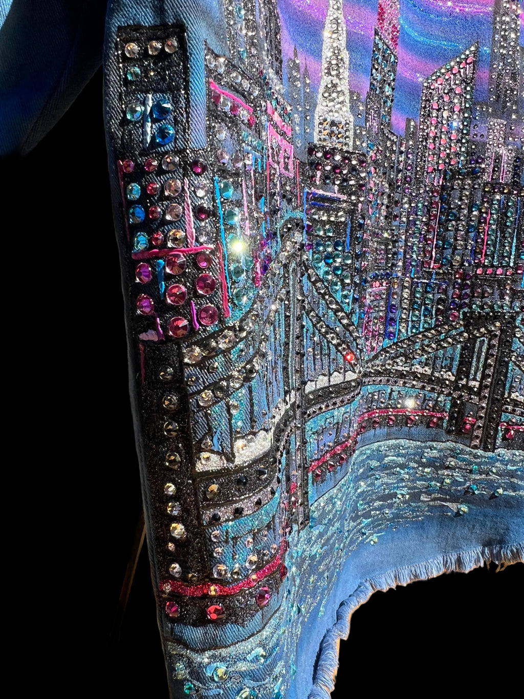 Colorful Loria NYC Art embellishments on a jacket with a scenic background