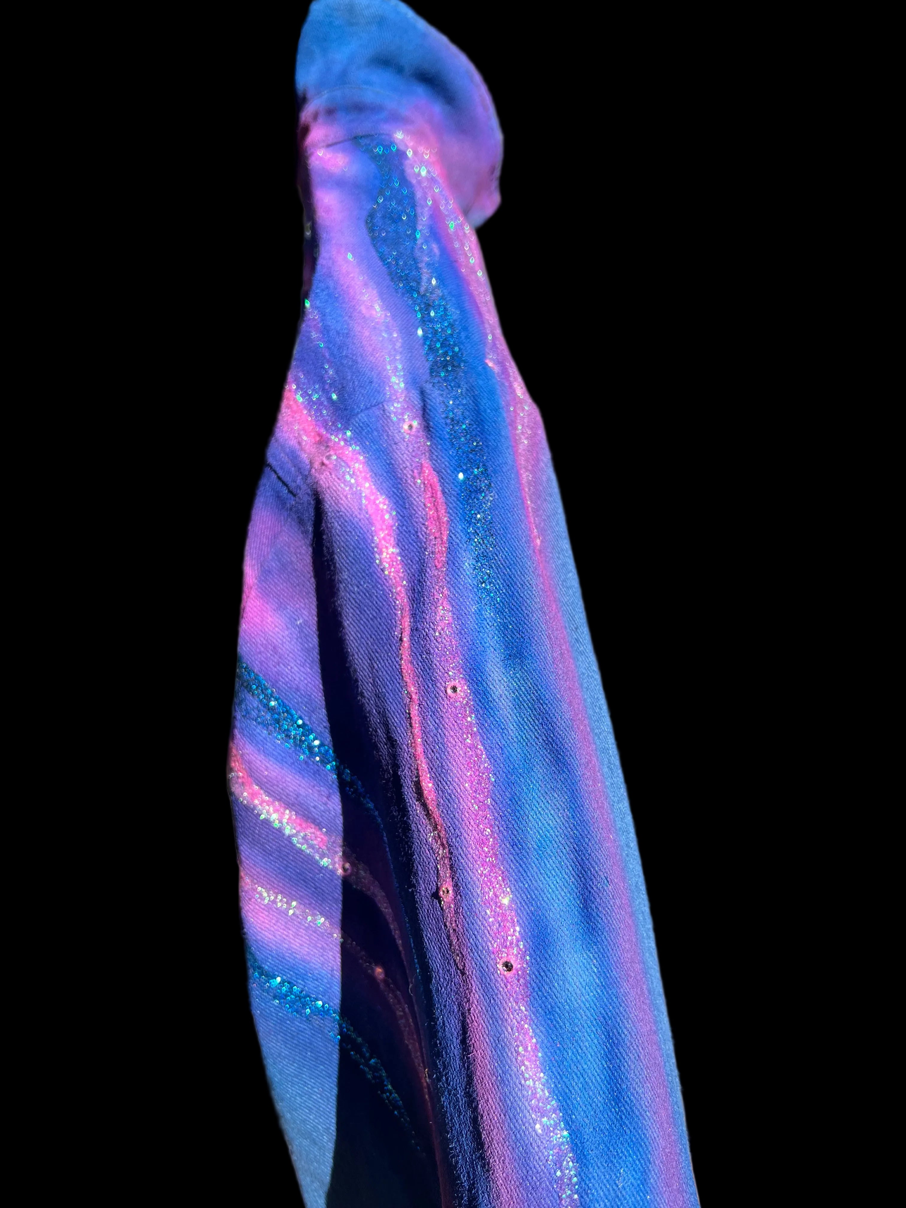 Colorful glittery Loria NYC Art fabric on a black background 