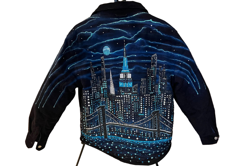 Blue jacket with a cityscape Loria NYC Art design on a stand in a room.