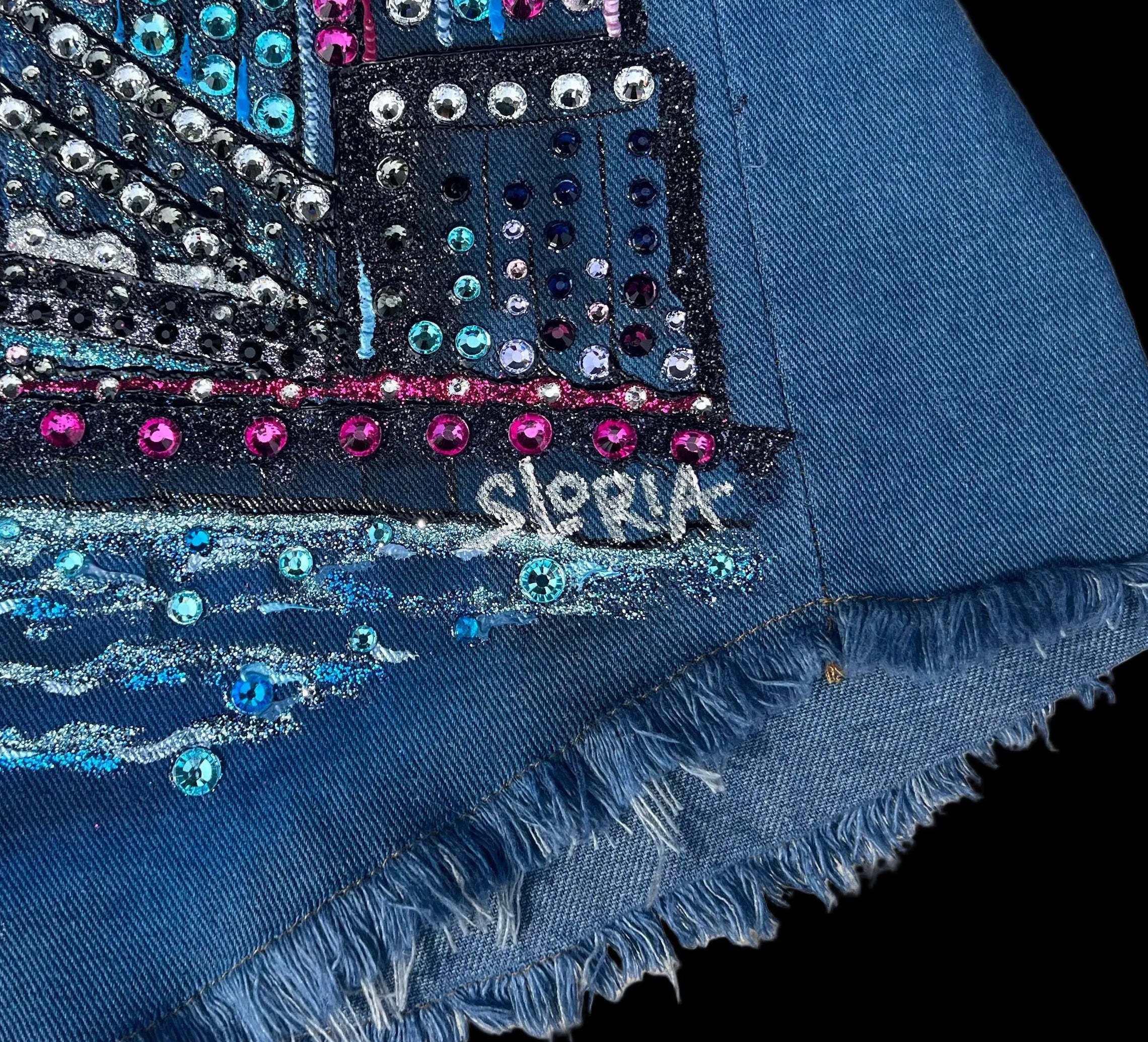 Blue fabric with decorative patterns and 'Sloria' branding on a fabric surface
