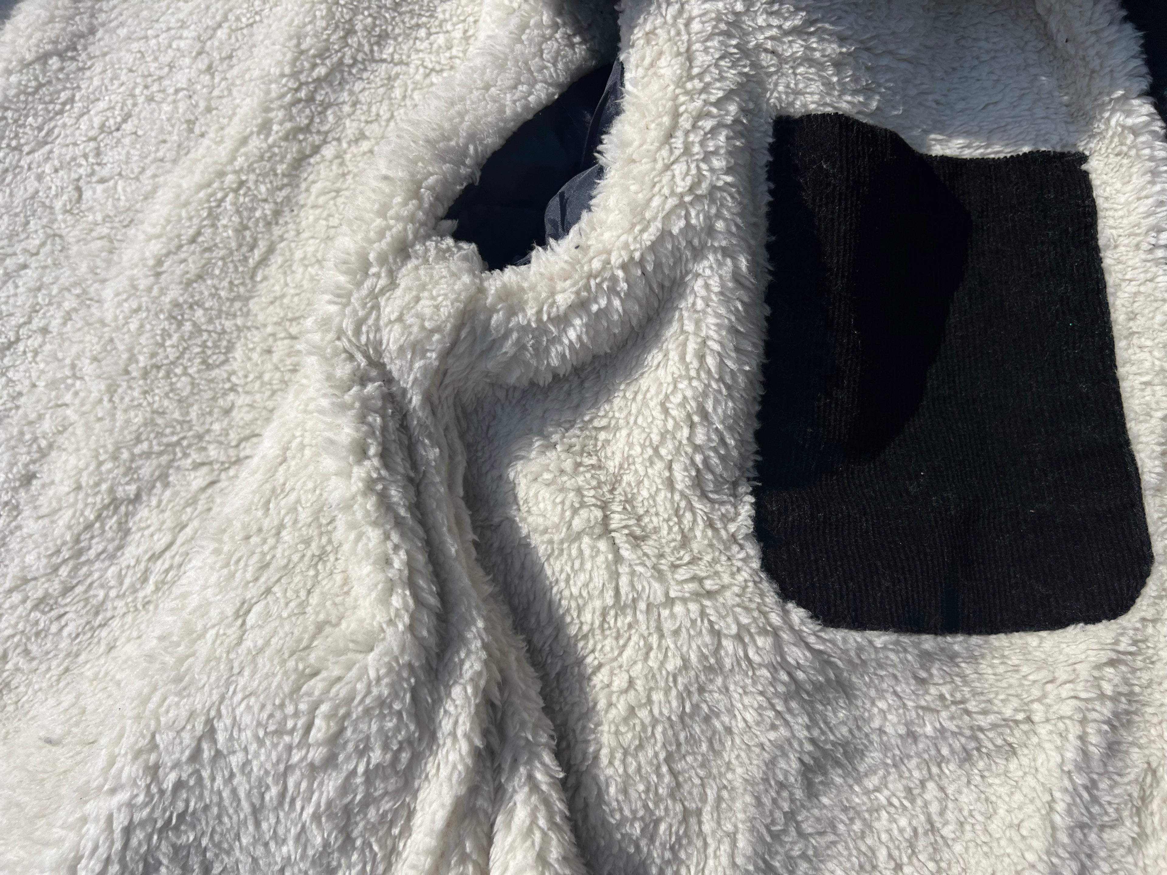 Close-up of a textured white fabric with black accents