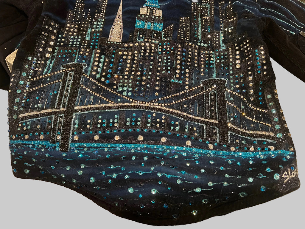 Navy blue jacket with a cityscape Loria NYC Art design featuring lights on a grey background