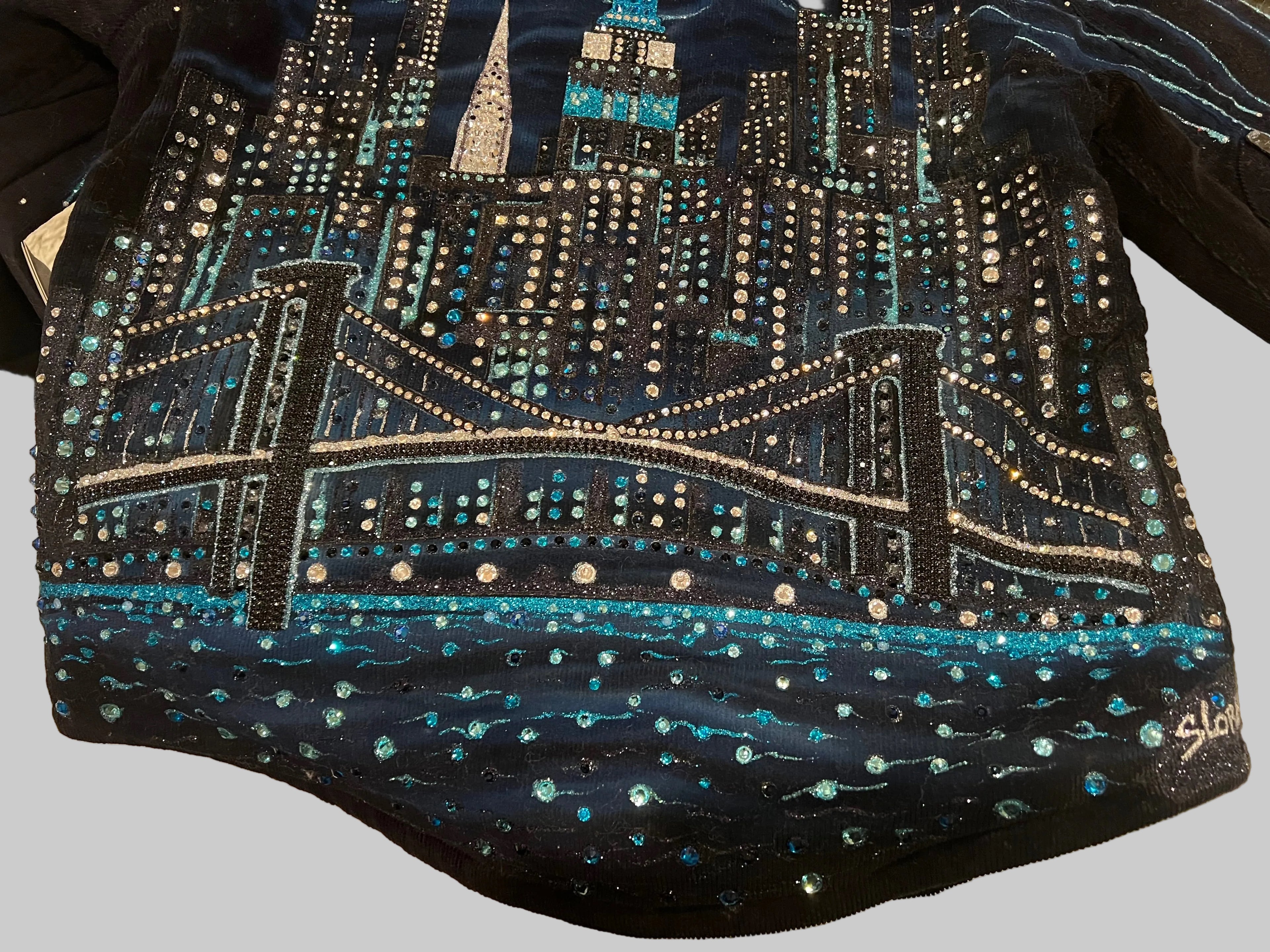 Navy blue jacket with a cityscape Loria NYC Art design featuring lights on a grey background