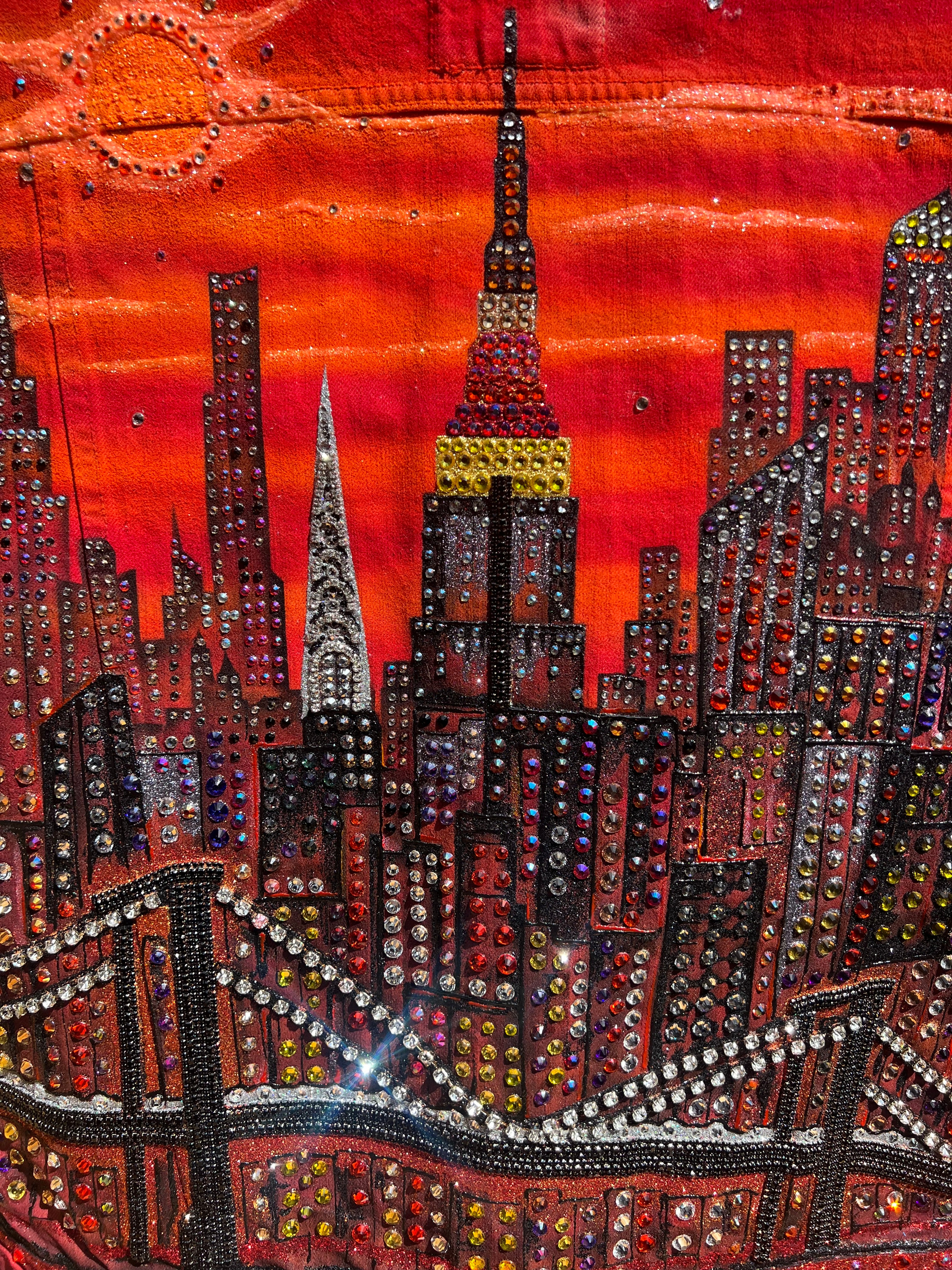 Close-up of a Loria NYC Art colorful, embellished fabric with intricate patterns and vibrant colors.