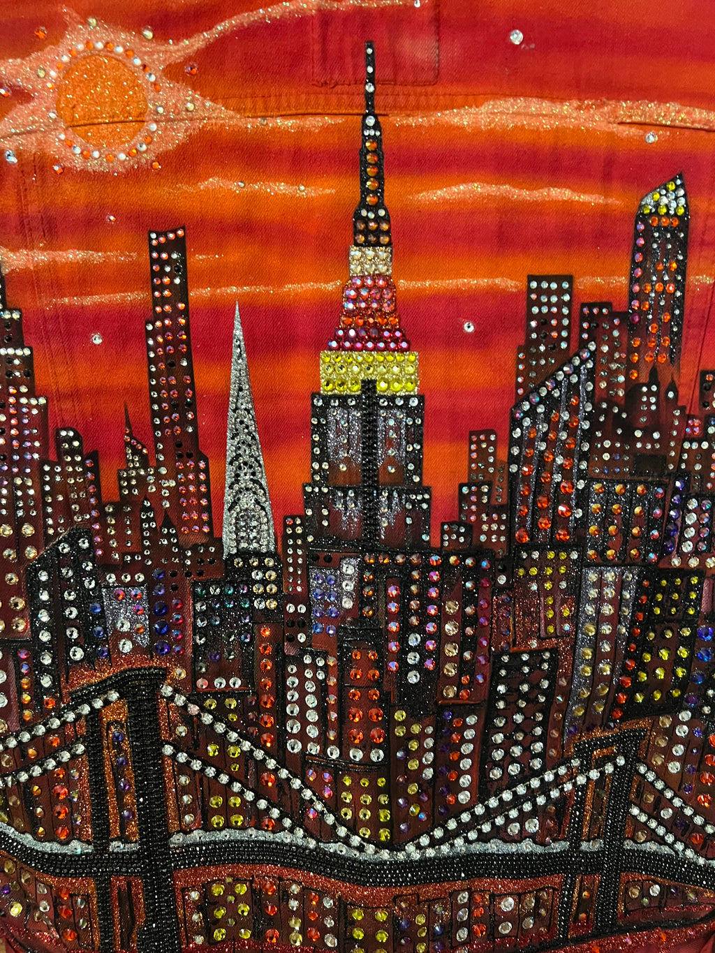 Decorative Loria NYC Art fabric with beadwork on a red background