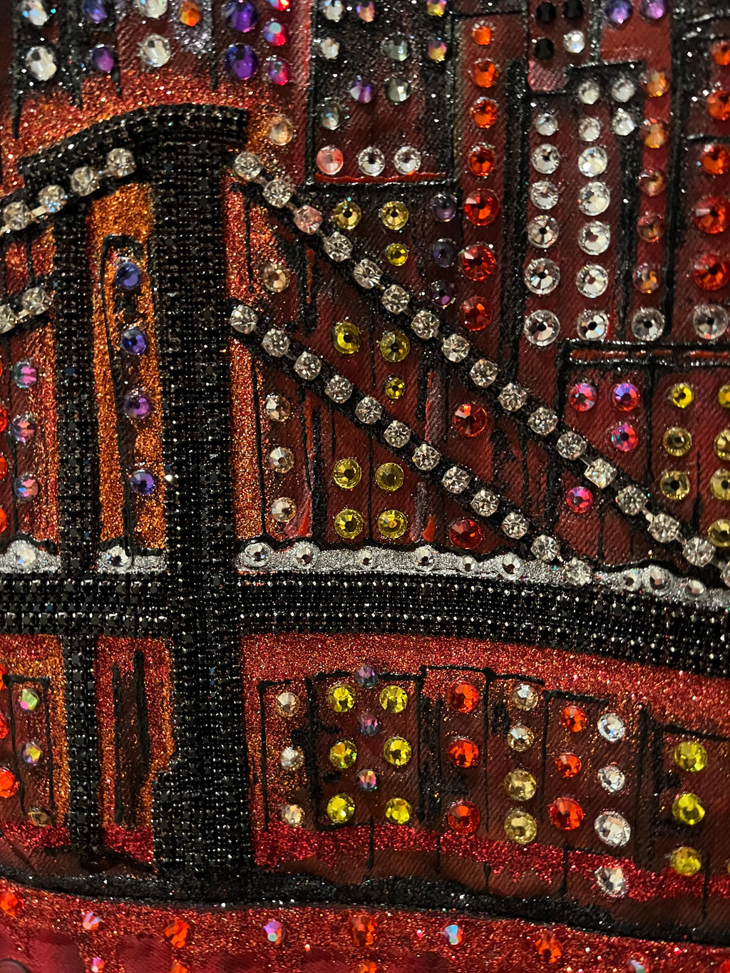 Close-up of a decorative Loria NYC Art  fabric with multicolored beads and sequins.