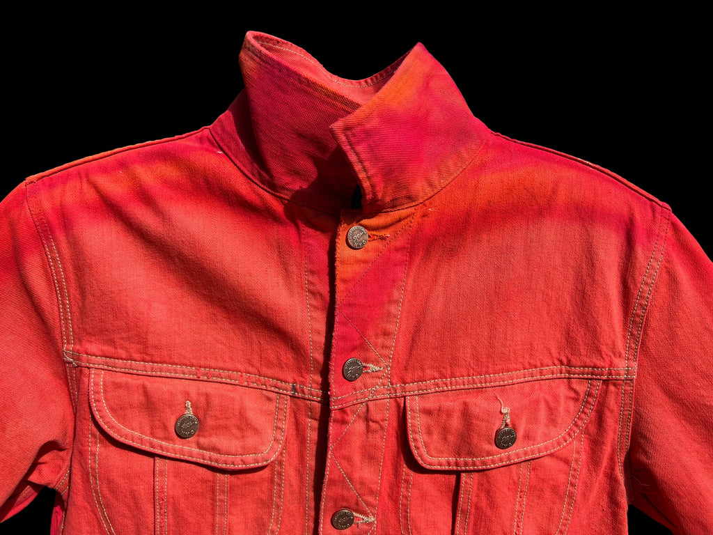 Red jacket with Loria NYC Art button details against a black background