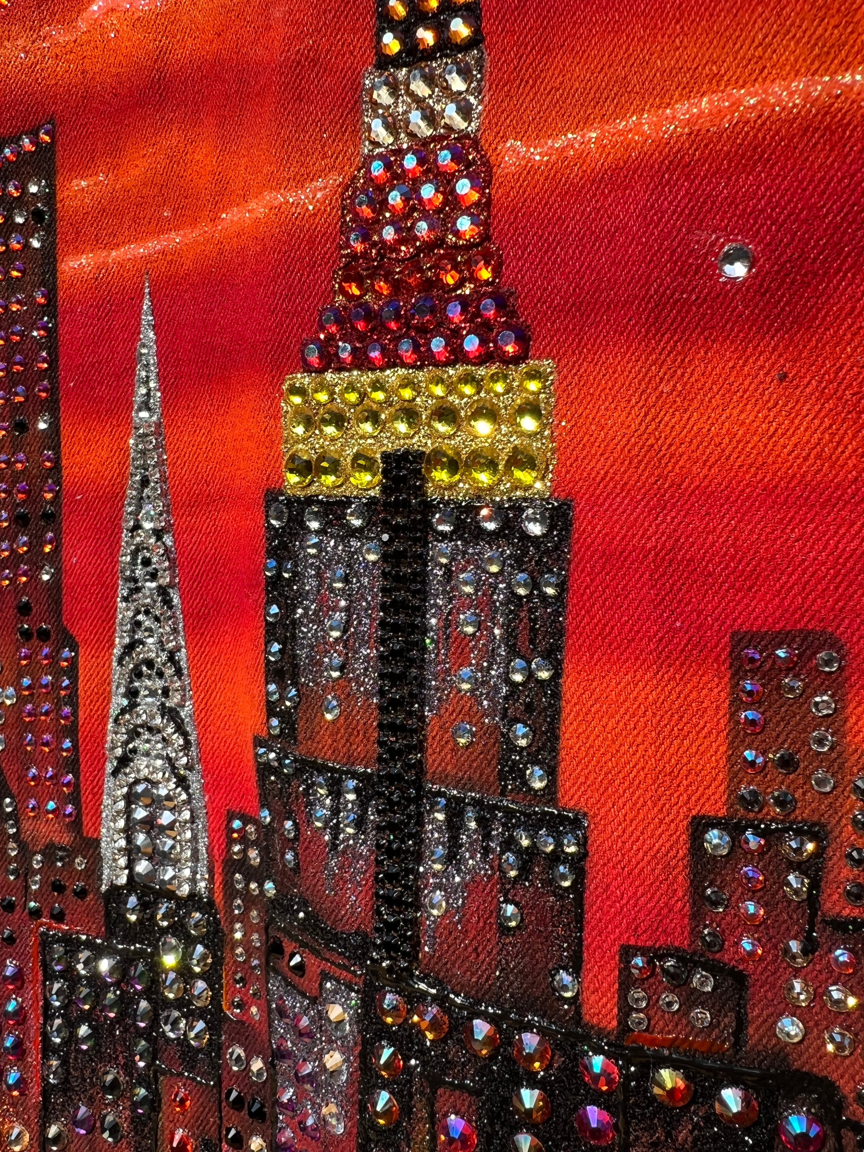 Close-up of a decorative  Loria NYC Art  fabric with rhinestones on a red background