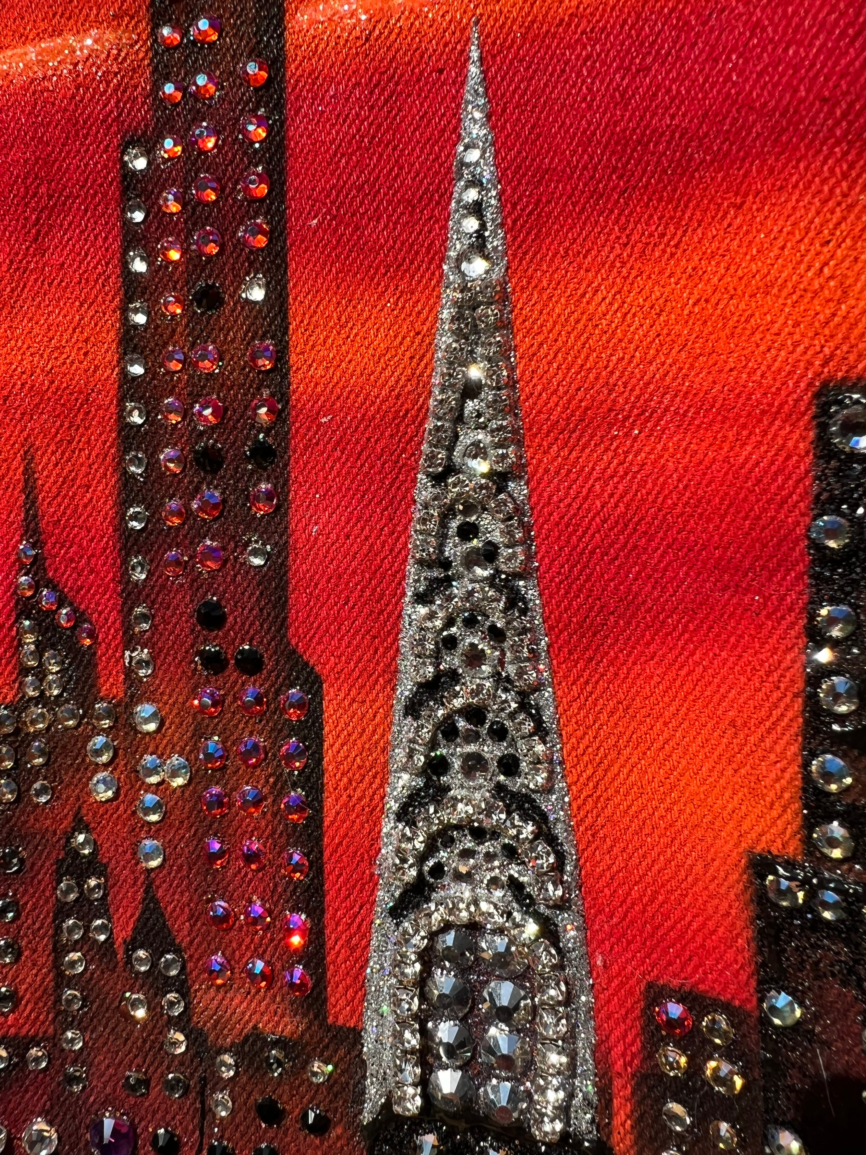Close-up of  Loria NYC Art decorative fabric with rhinestones on a red background