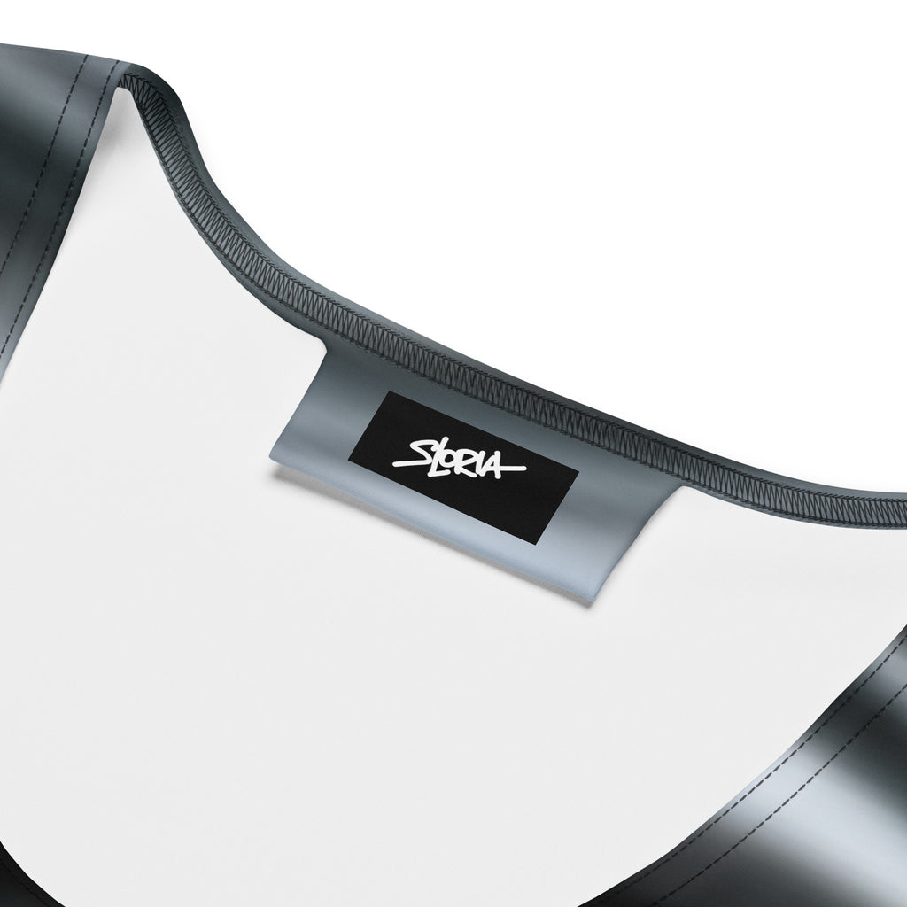 Close-up of a black and white dress with 'S.Loria' designer brand label on a white background