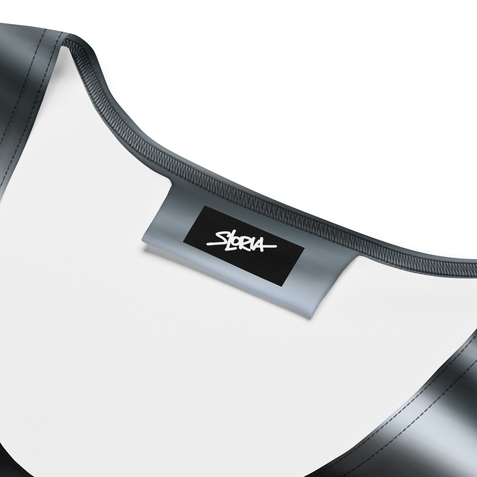 Close-up of a black and white dress with 'S.Loria' designer brand label on a white background