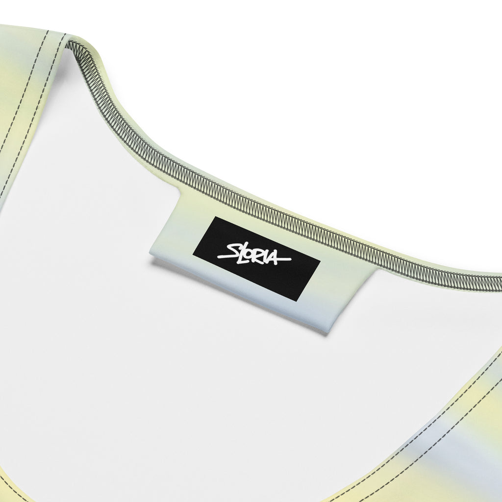 Close-up of a yellow white garment with a black label featuring the brand 'S.Loria' on a white background.