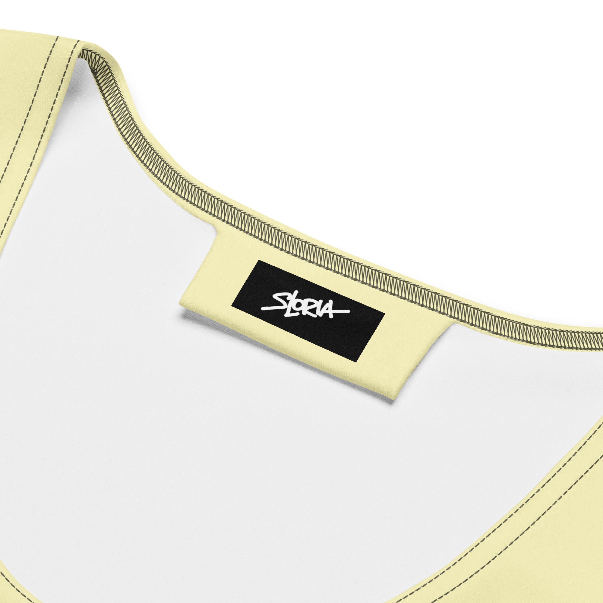 Close-up of a yellow sports bra with a brand label S.Loria on a white background
