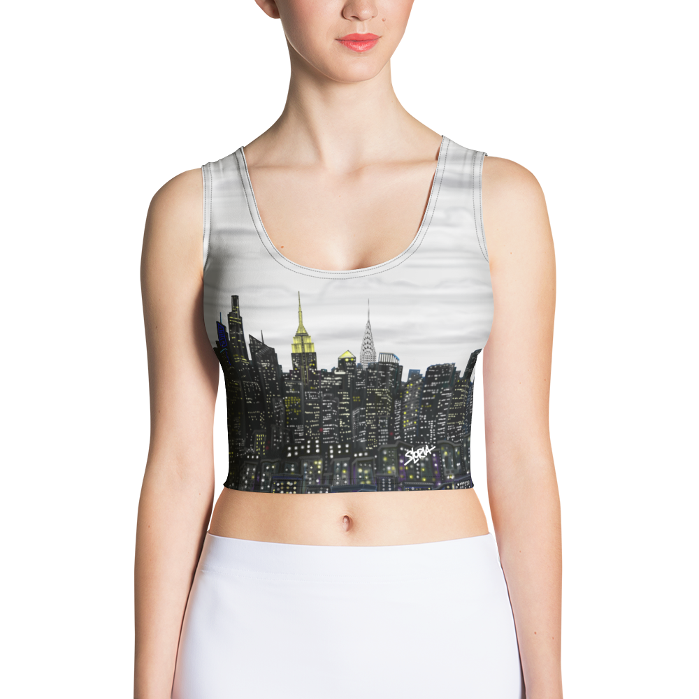 Person wearing a Loria NYC Art crop top with a cityscape design on a white background