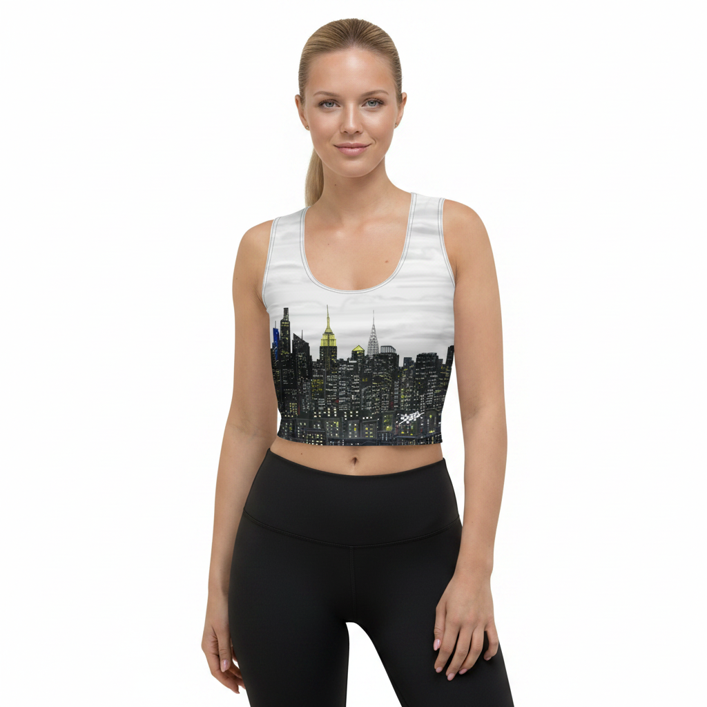 Woman wearing a Loria NYC Art sports bra with a city skyline design on a white background