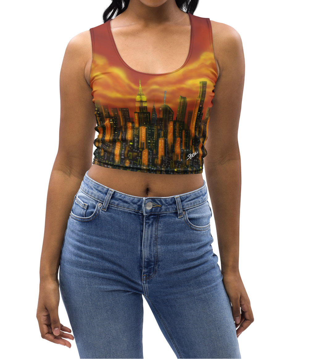 Woman wearing a colorful Loria NYC Art tank top and blue jeans on a white background
