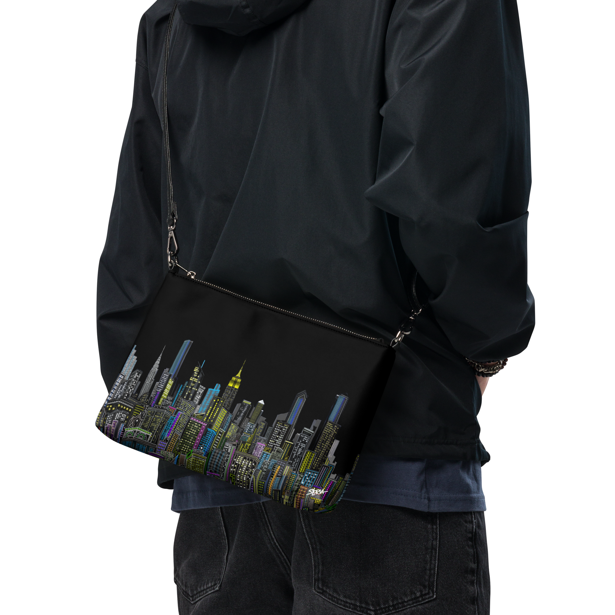 Person wearing a black jacket with a colorful Loria NYC Art cityscape bag on a transparent background