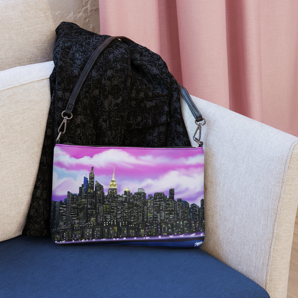Crossbody bag with a Loria NYC Art city skyline design on chair