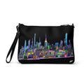 Black crossbody bag with colorful Loria NYC Art cityscape design on a white background