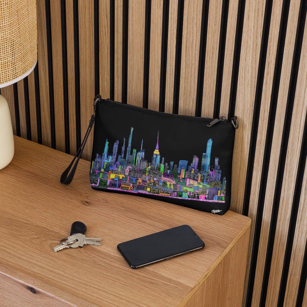 Black crossbody bag with colorful Loria NYC Art interior setting