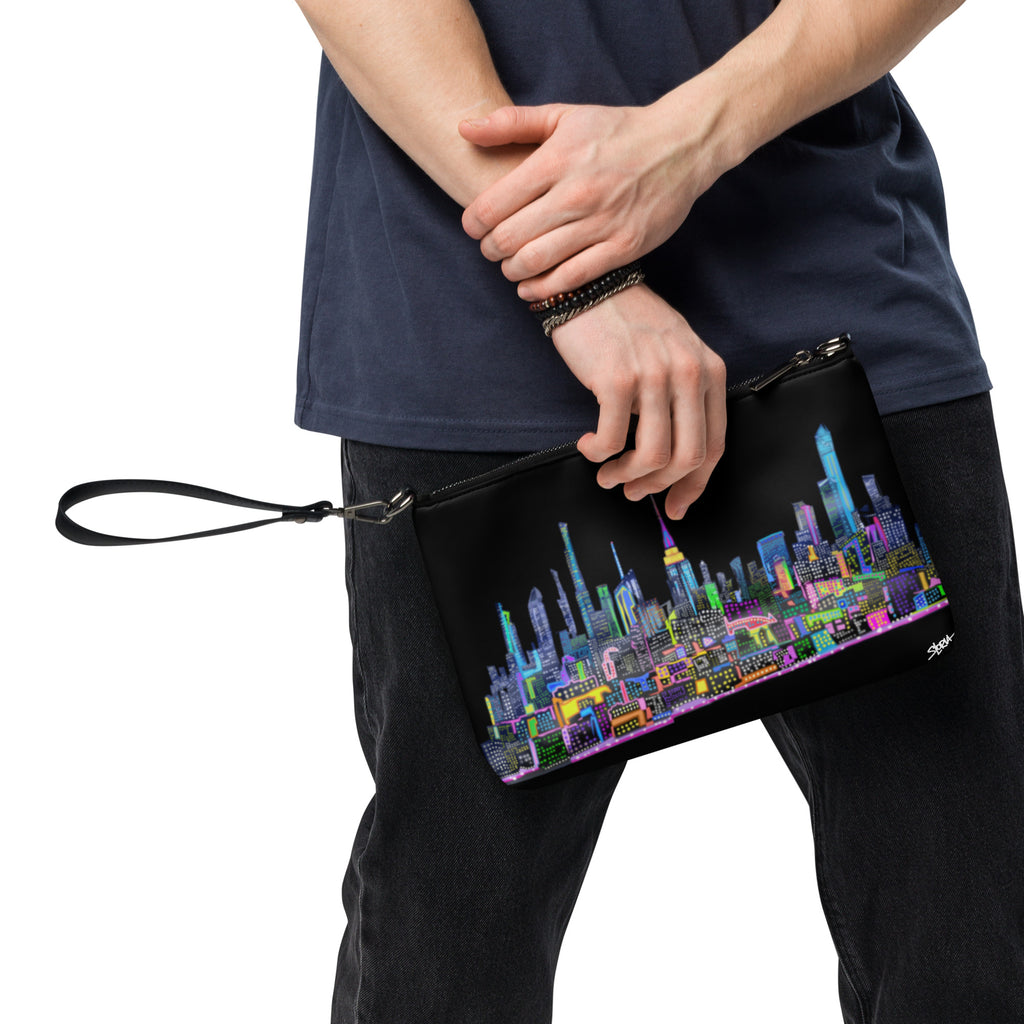 Person holding a black colorful cityscape crossbody bag by Loria NYC Art 