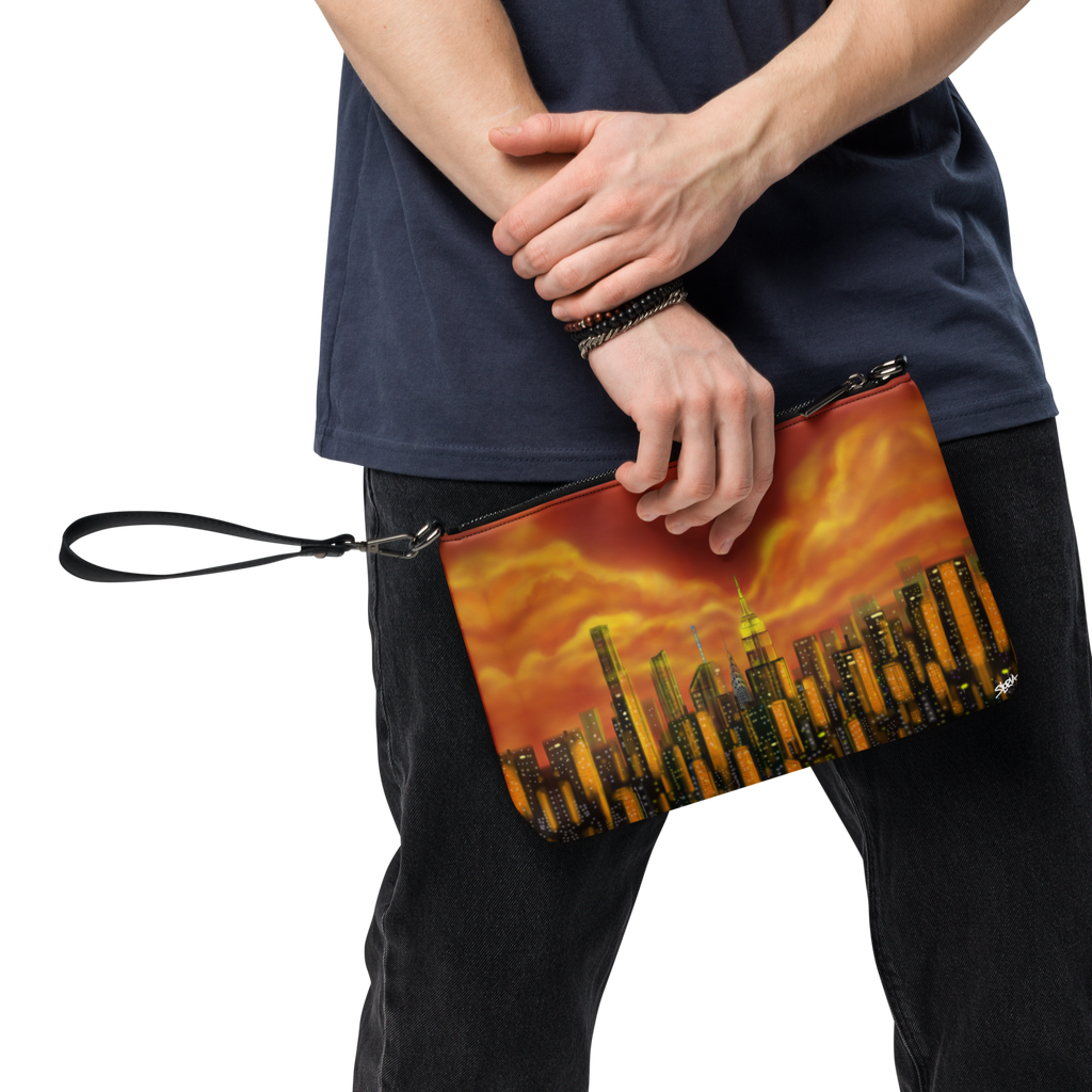 Person holding a clutch with a cityscape Loria NYC Art design against a white background