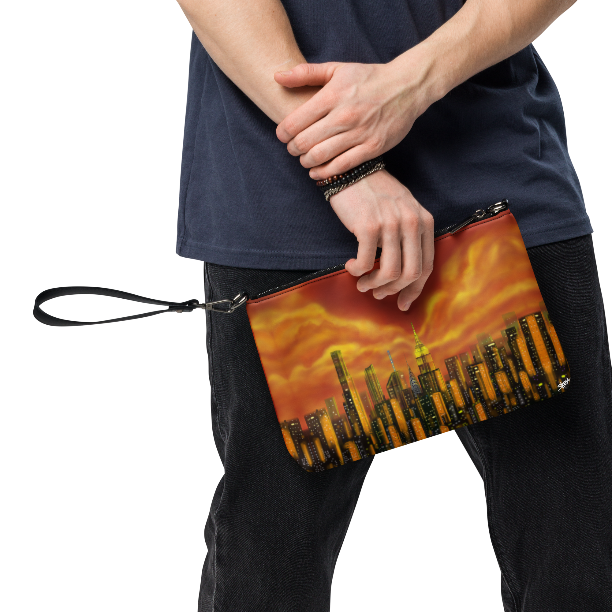 Person holding a clutch with a cityscape Loria NYC Art design against a white background