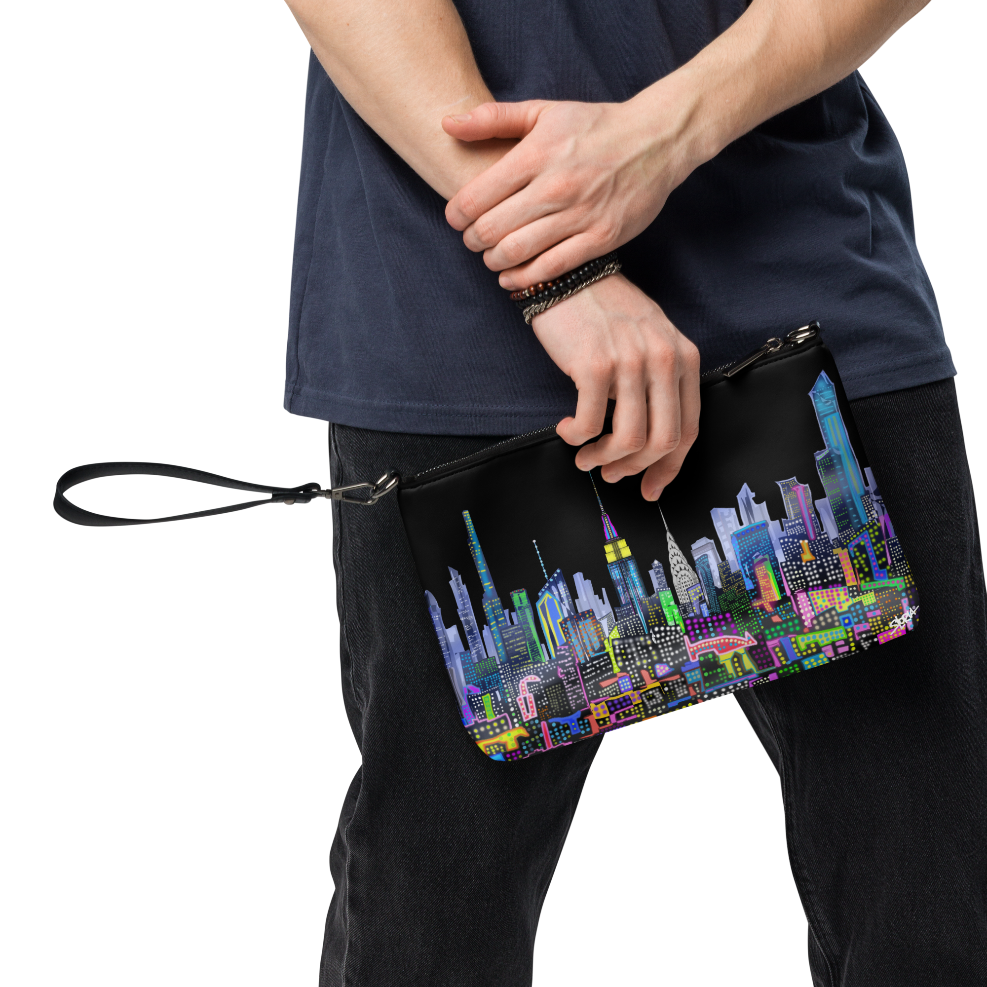 Person holding a colorful Loria NYC Art cityscape clutch bag with a transparent background