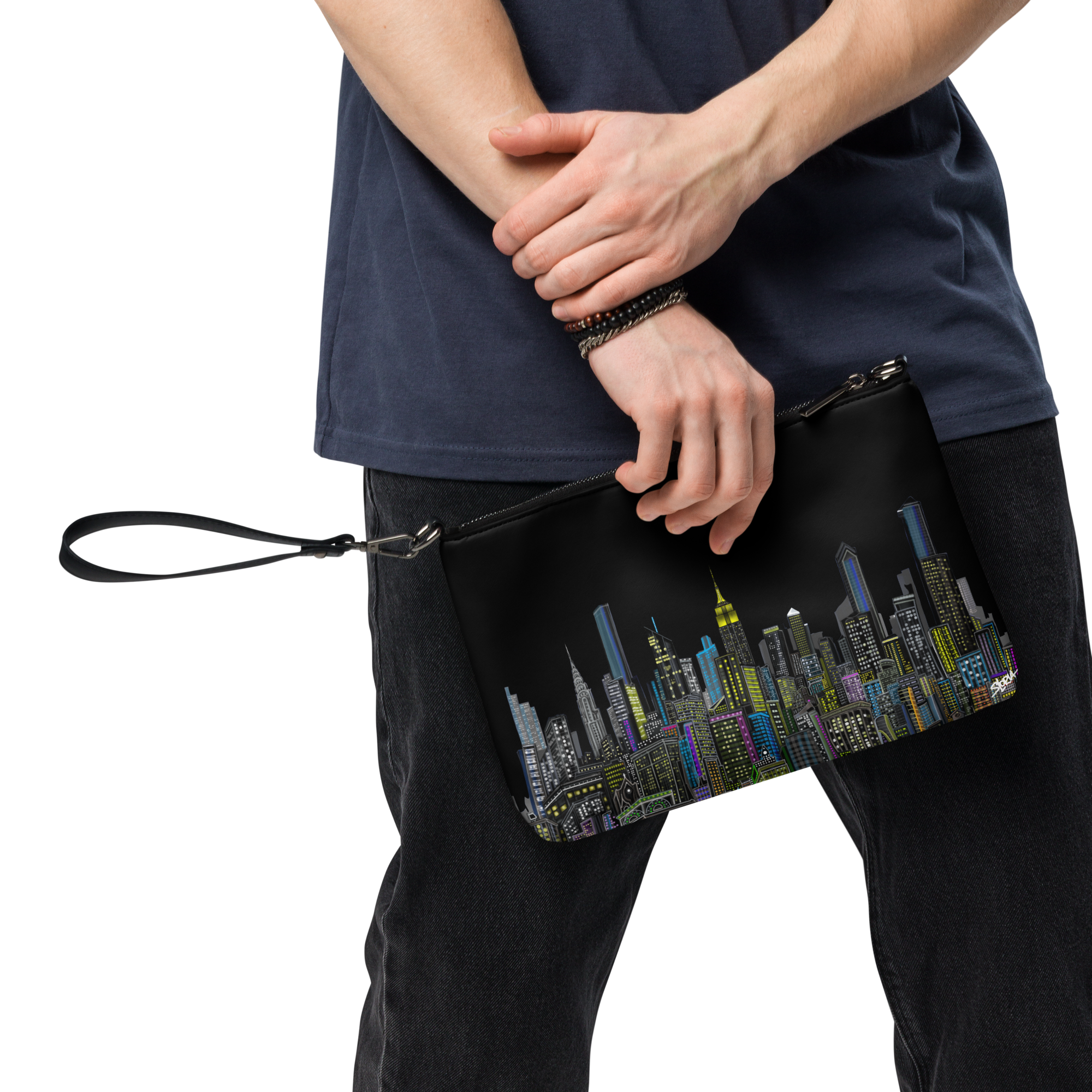Person holding a Loria NYC Art black clutch with cityscape design