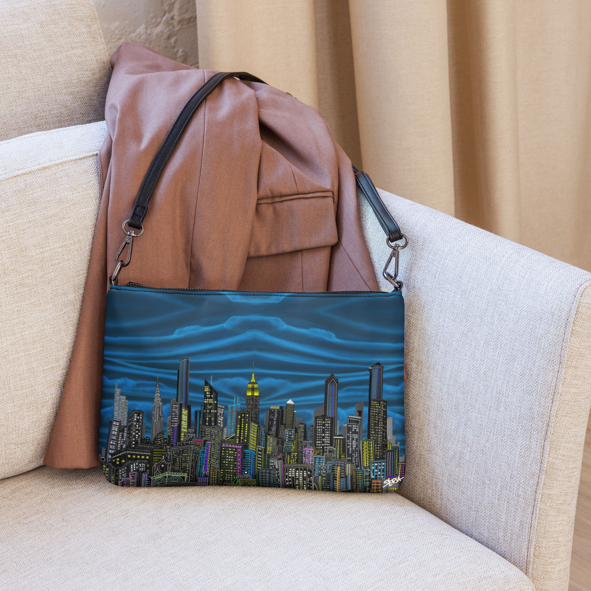 Blue pouch with cityscape Loria NYC Art design on a beige couch
