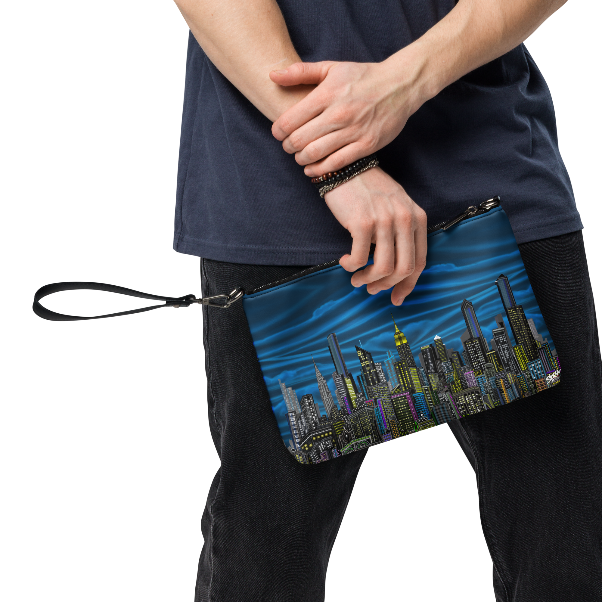 Person holding a Loria NYC Art blue clutch with cityscape design