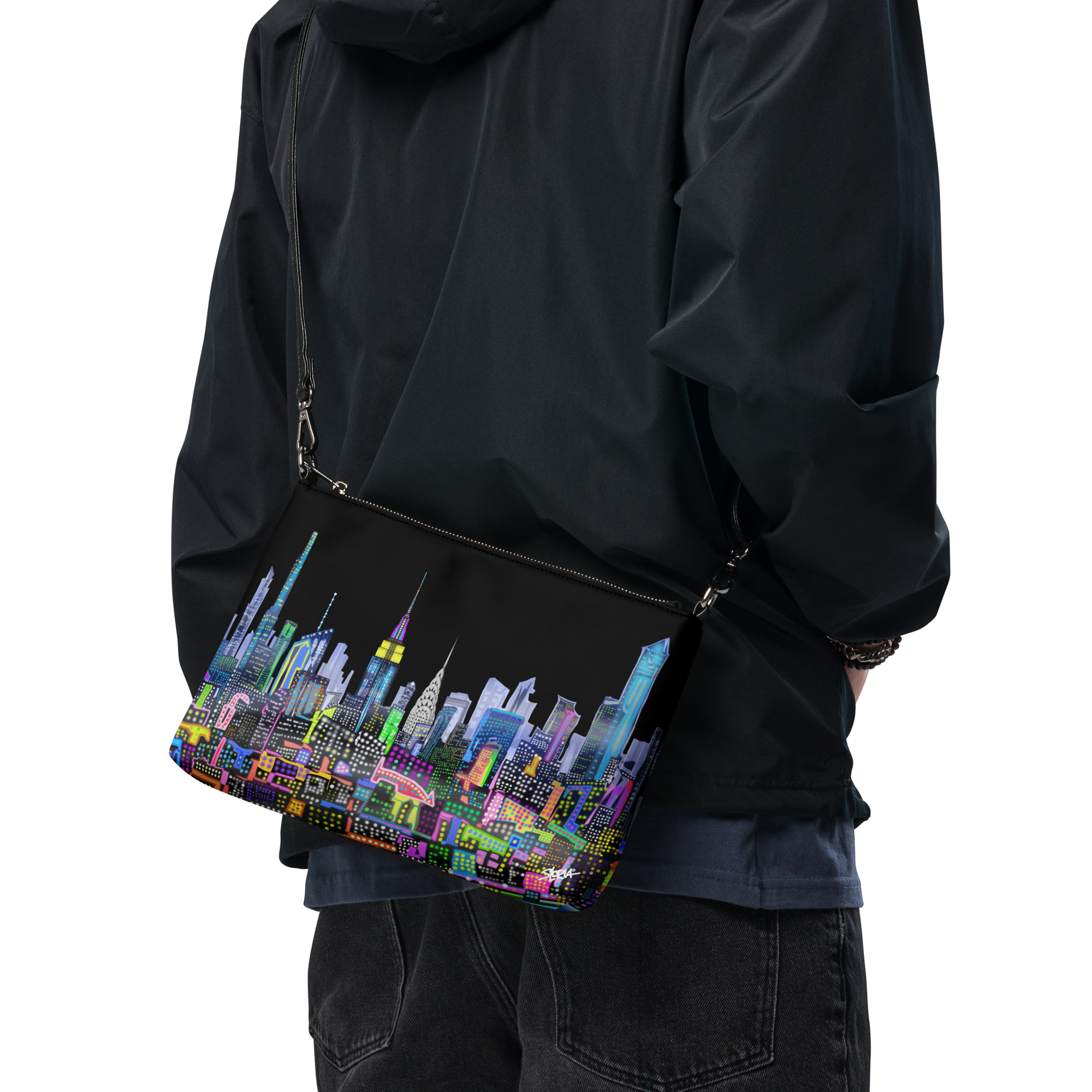 Person wearing a black jacket with a Loria NYC Art colorful cityscape bag
