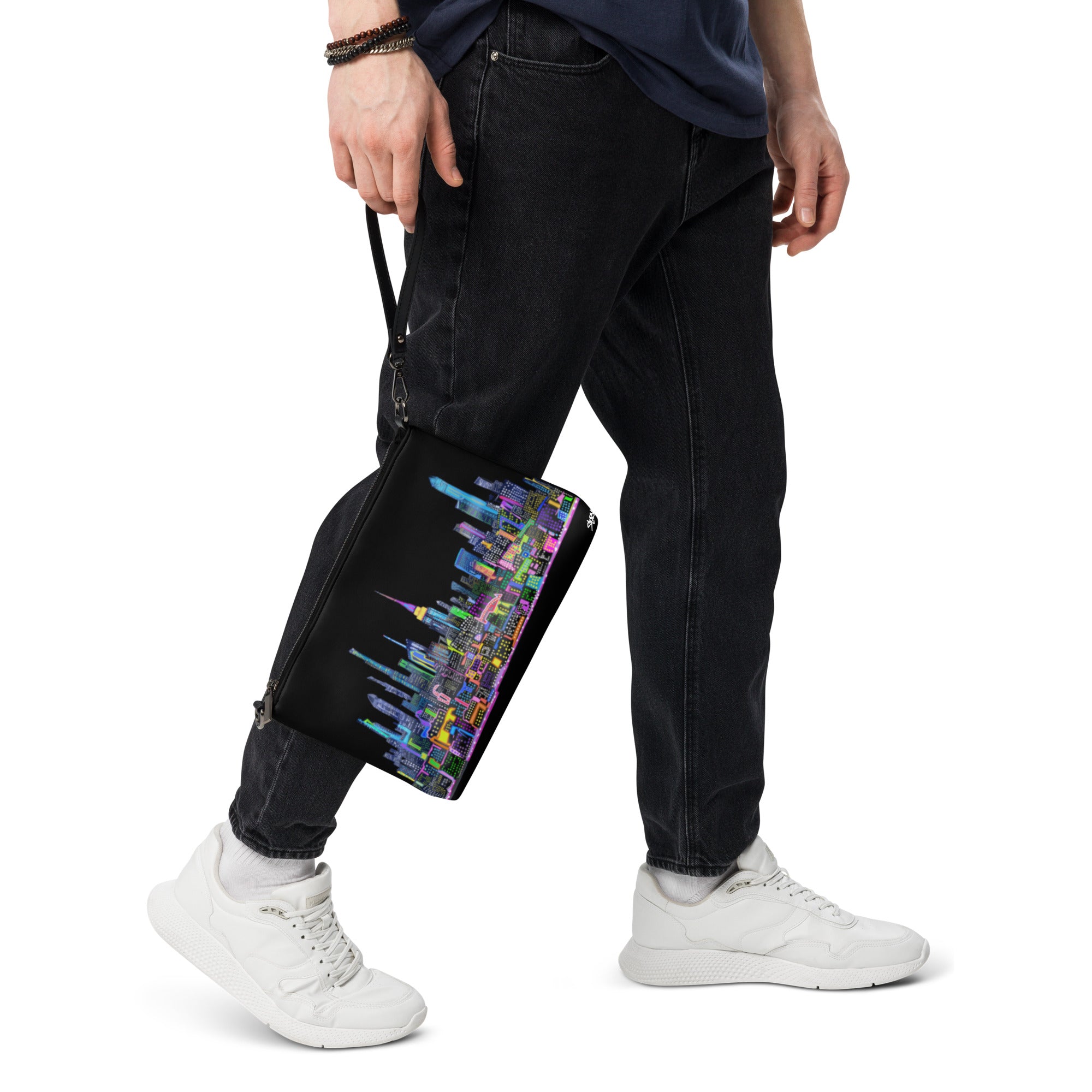 Person holding a Black crossbody bag with colorful Loria NYC Art cityscape design 