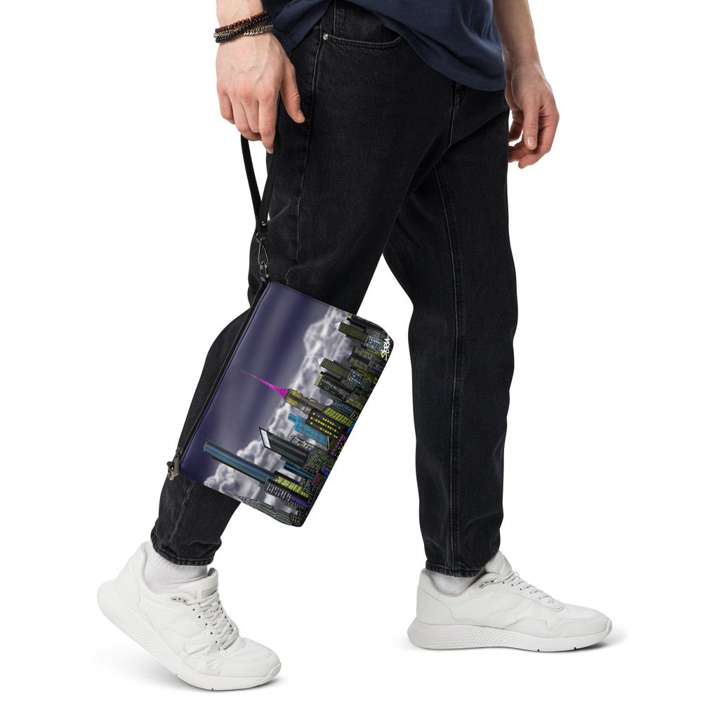 Person holding a black bag with a colorful design on a white background