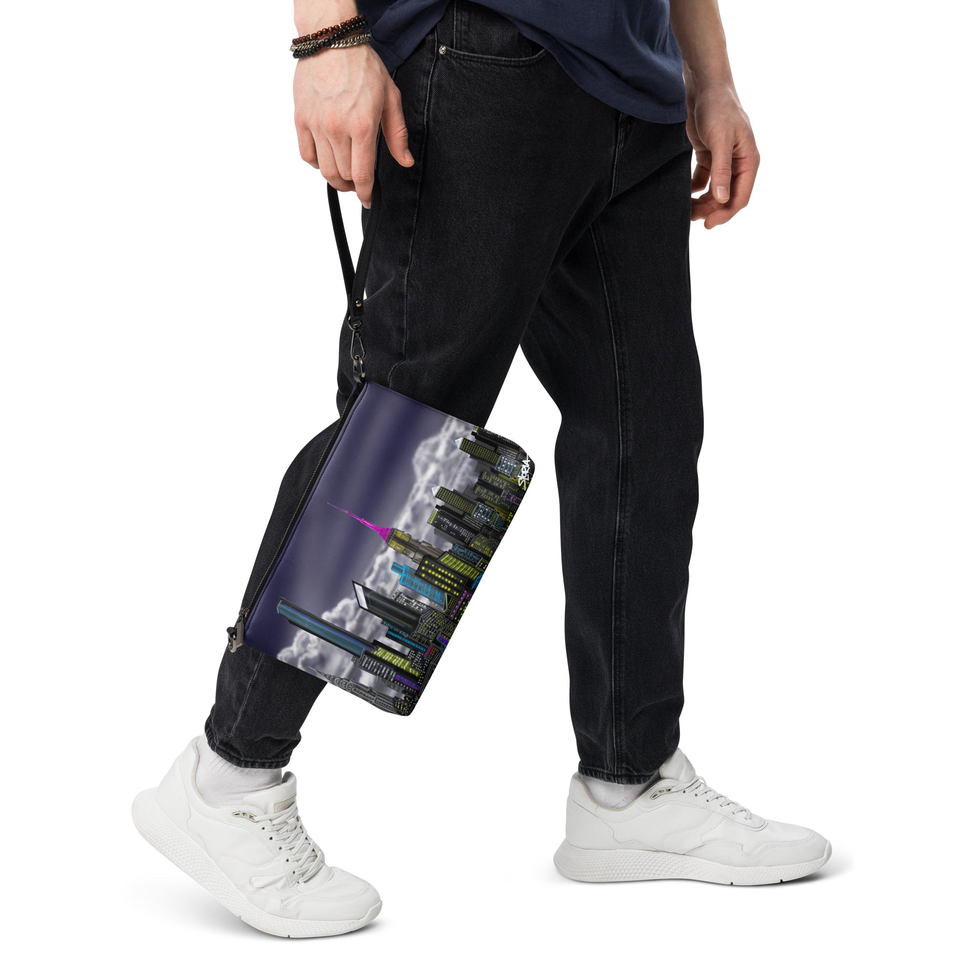 Person holding a black bag with a colorful design on a white background