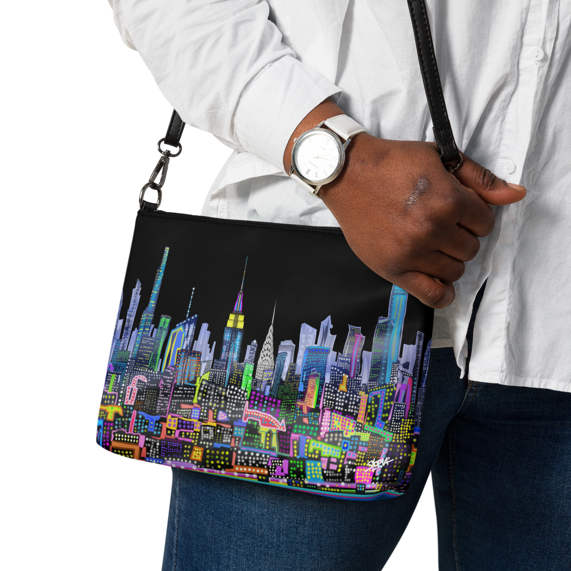 Person holding a colorful cityscape Loria NYC Art bag with a black background